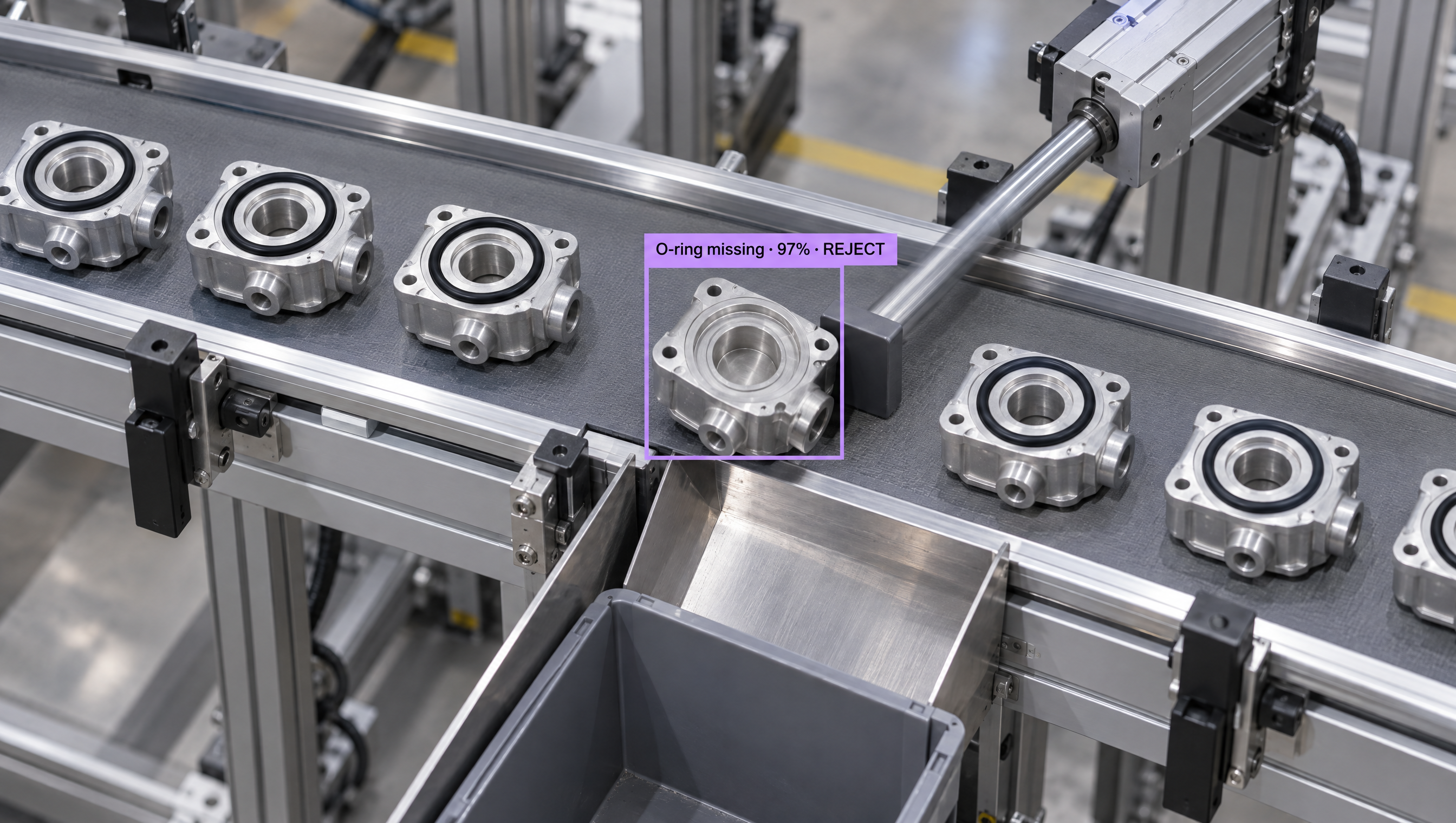 Metal parts on a factory conveyor belt, with one highlighted by an AI system as "O-ring missing" and marked for rejection.