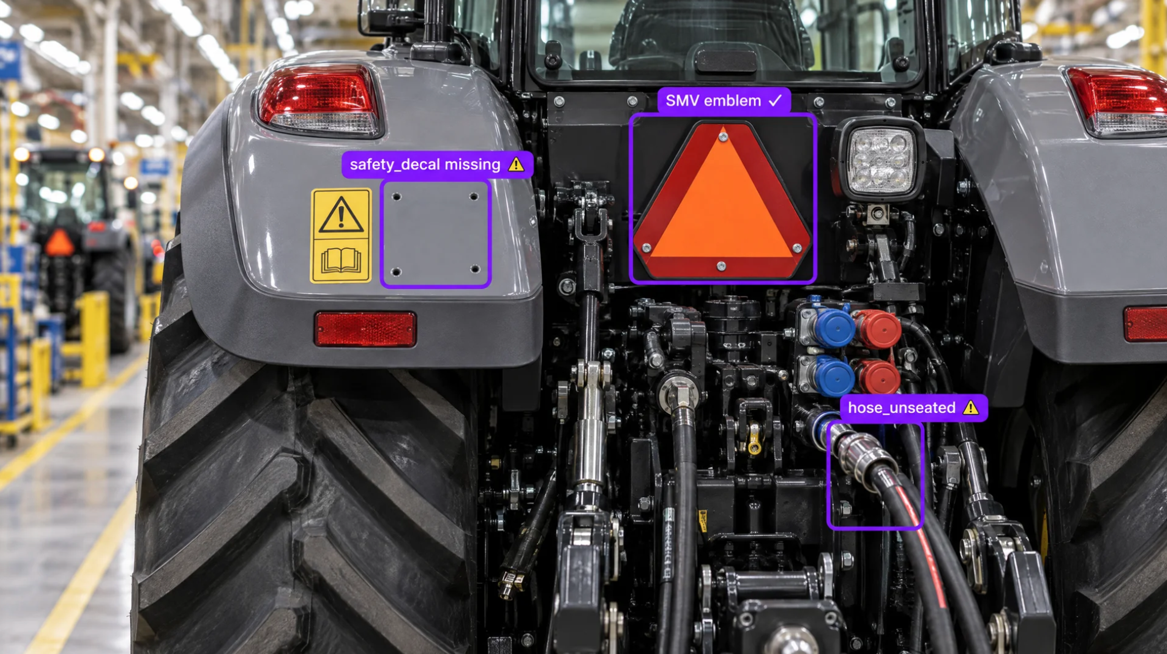 Rear view of a grey tractor highlighting a missing safety decal and an unseated hydraulic hose.