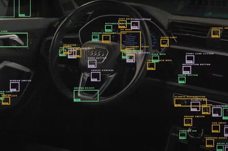 Car interior with object detection boxes and labels on dashboard, steering wheel, and door components.