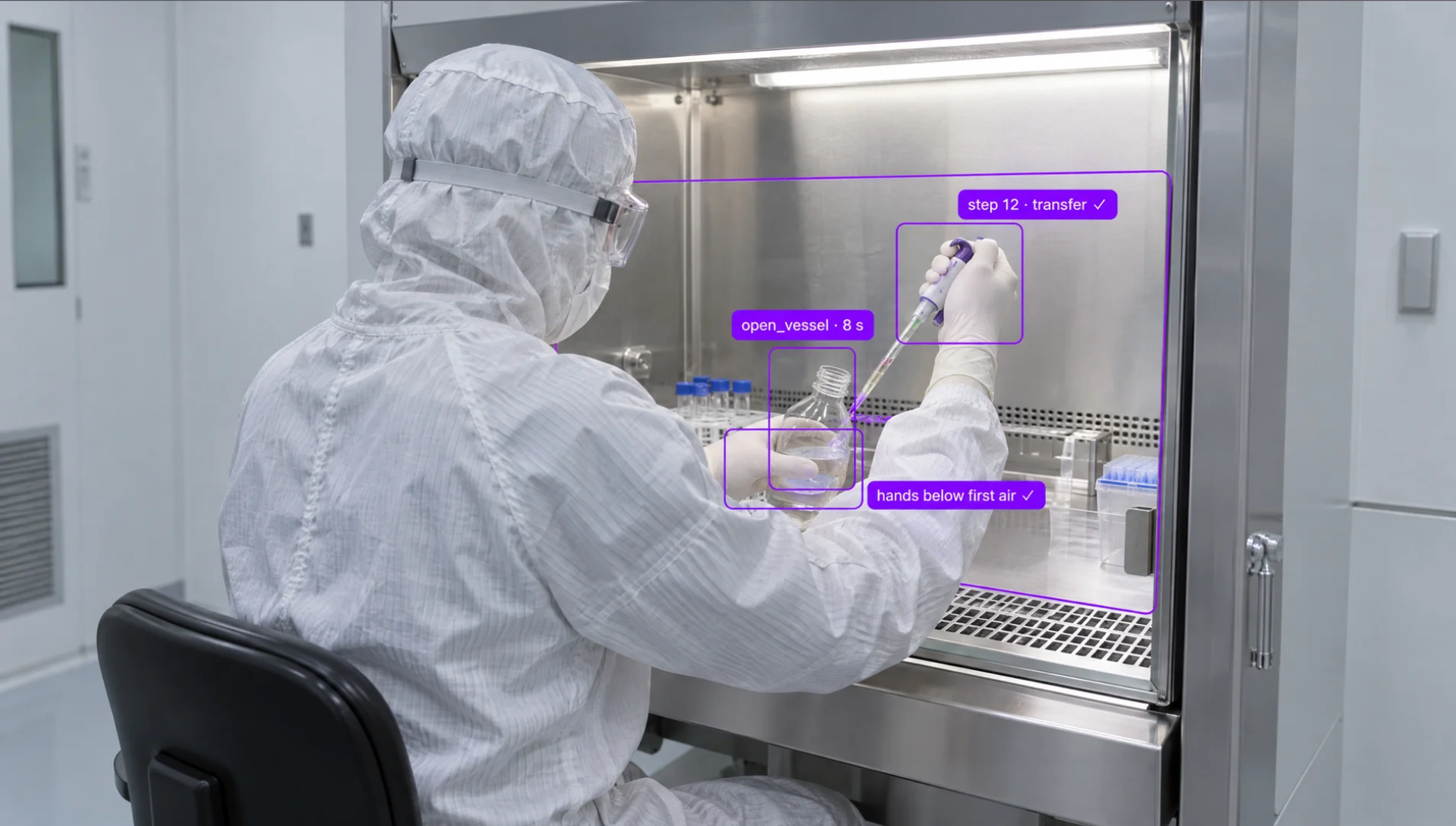 A person in a cleanroom suit pipettes inside a sterile lab hood, guided by augmented reality overlays.