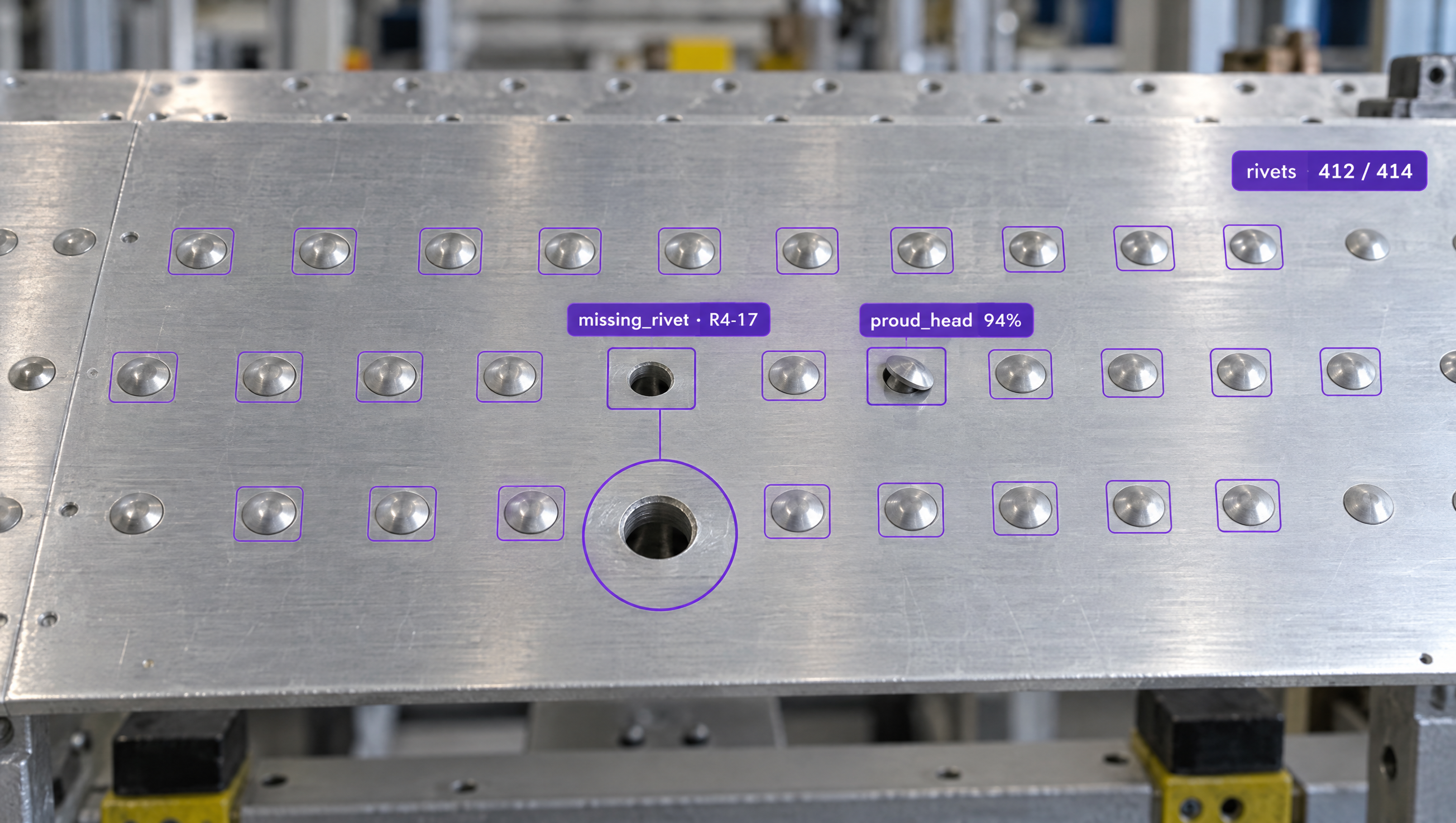 AI inspection of a riveted metal panel, highlighting a missing rivet and a proud rivet head among many outlined rivets.