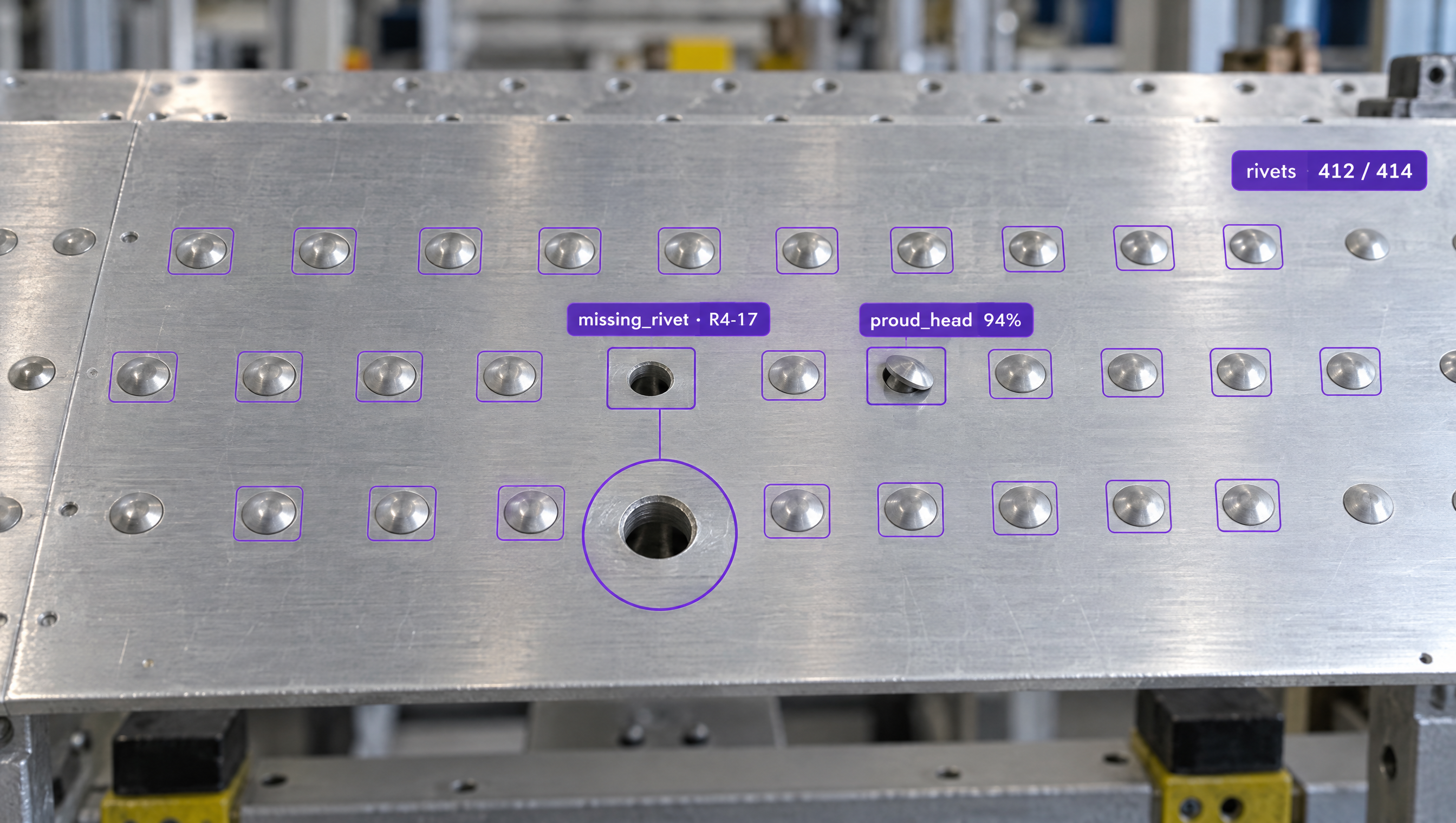 AI inspection of a riveted metal panel, highlighting a missing rivet and a proud rivet head among many outlined rivets.