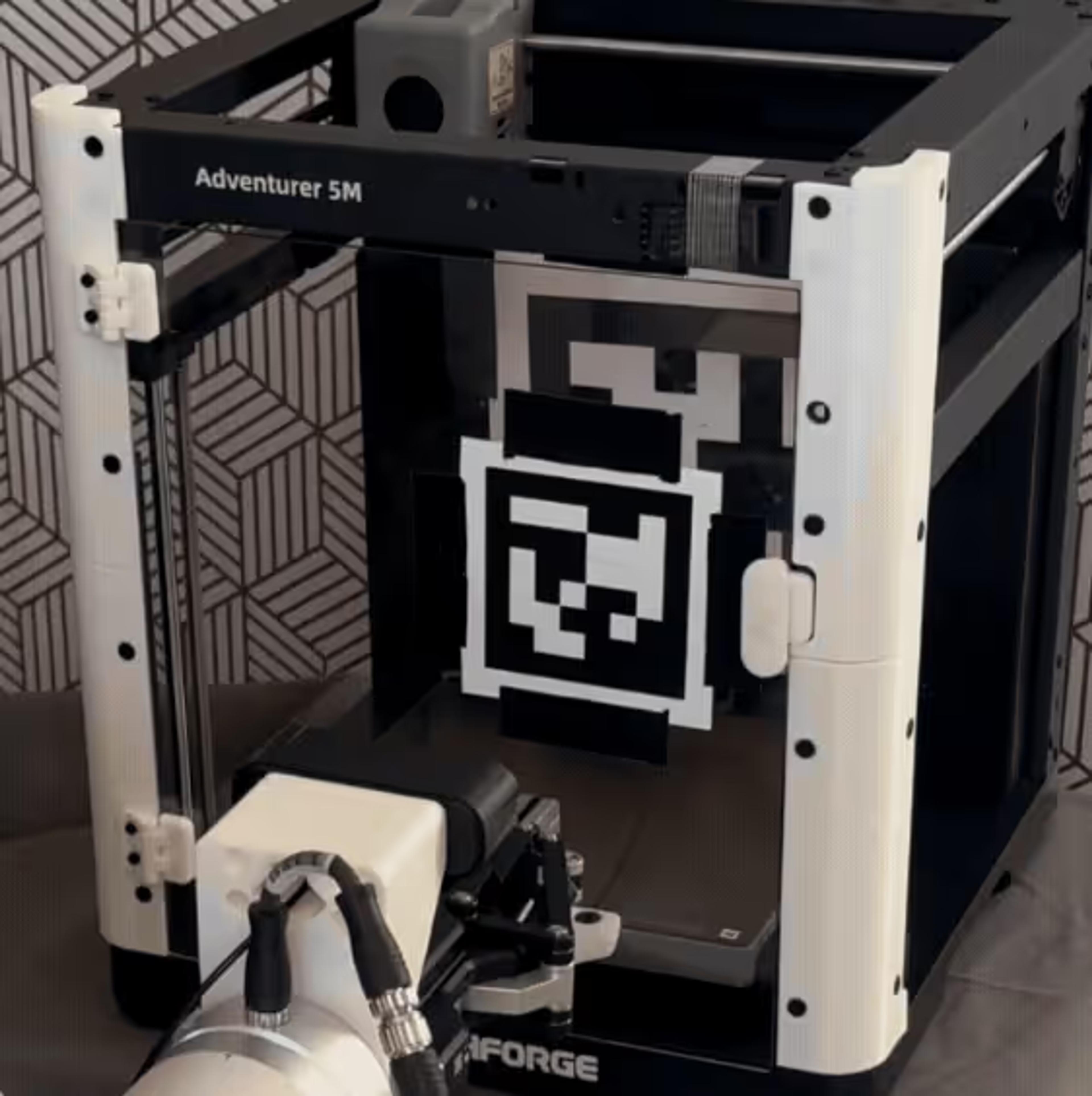Robot arm tending a 3D printer