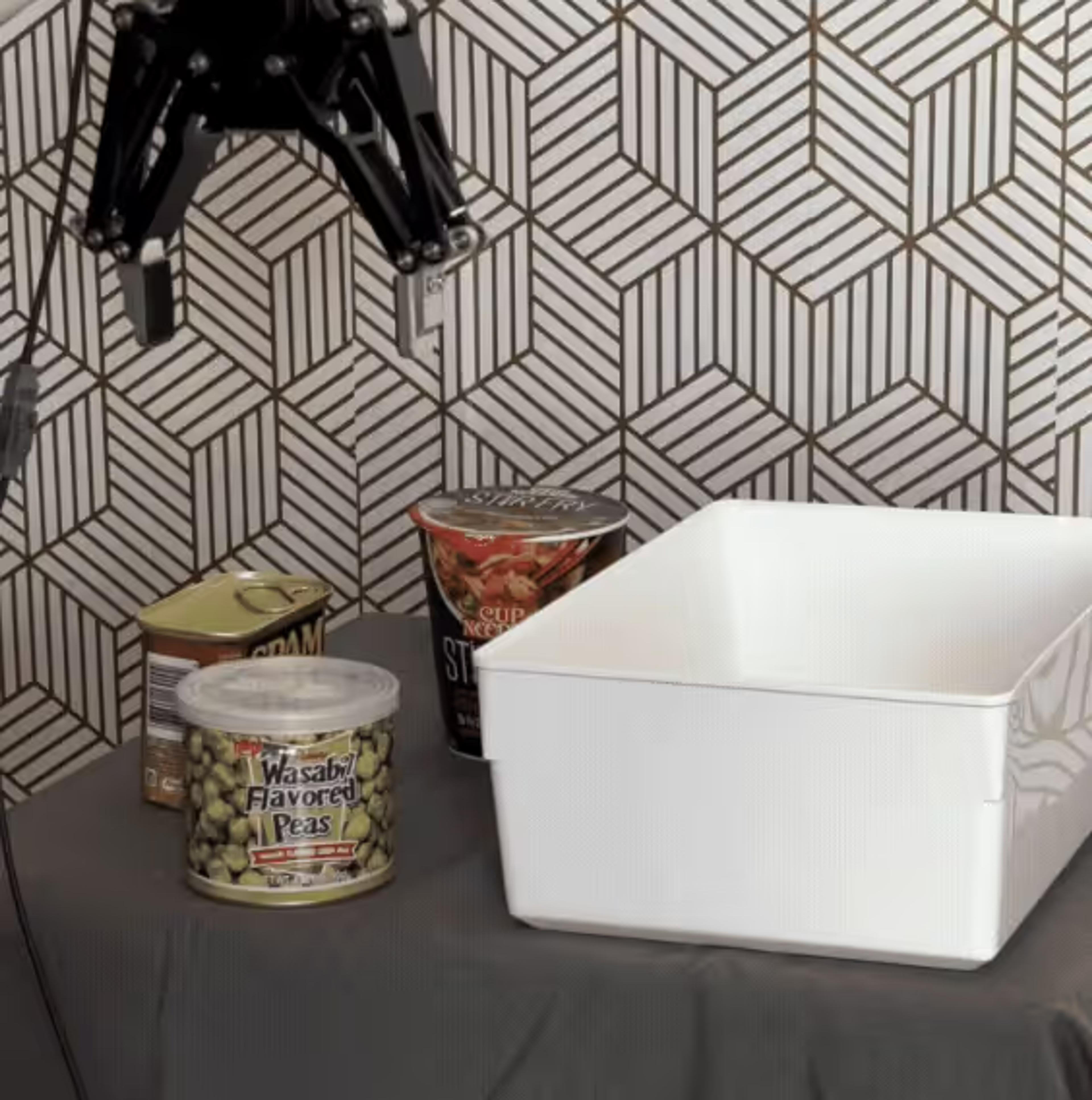 Robot gripper picking packaged food into a bin