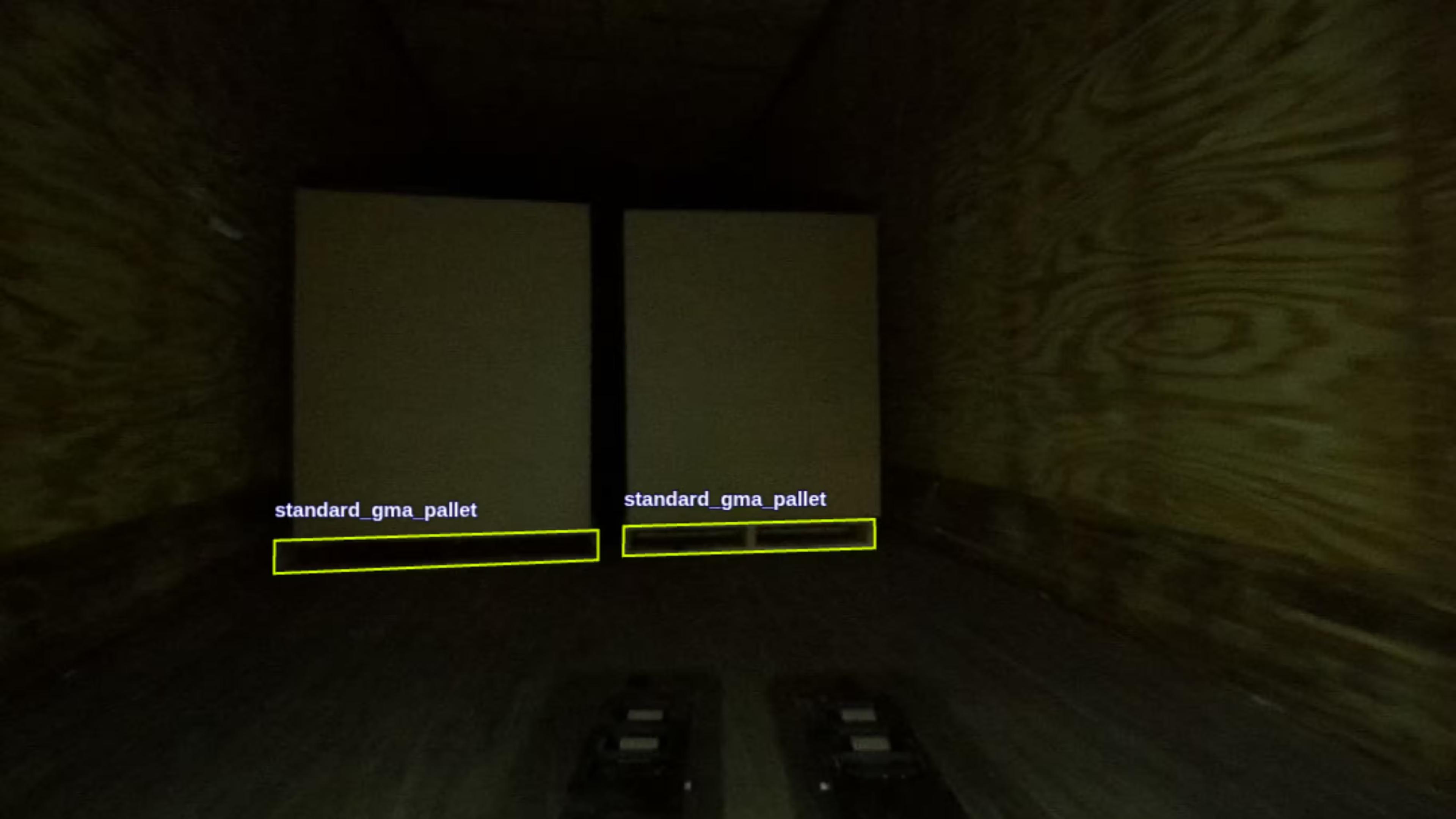 The view from a robot camera inside a dimly lit trailer, two pallets detected and labeled standard_gma_pallet.