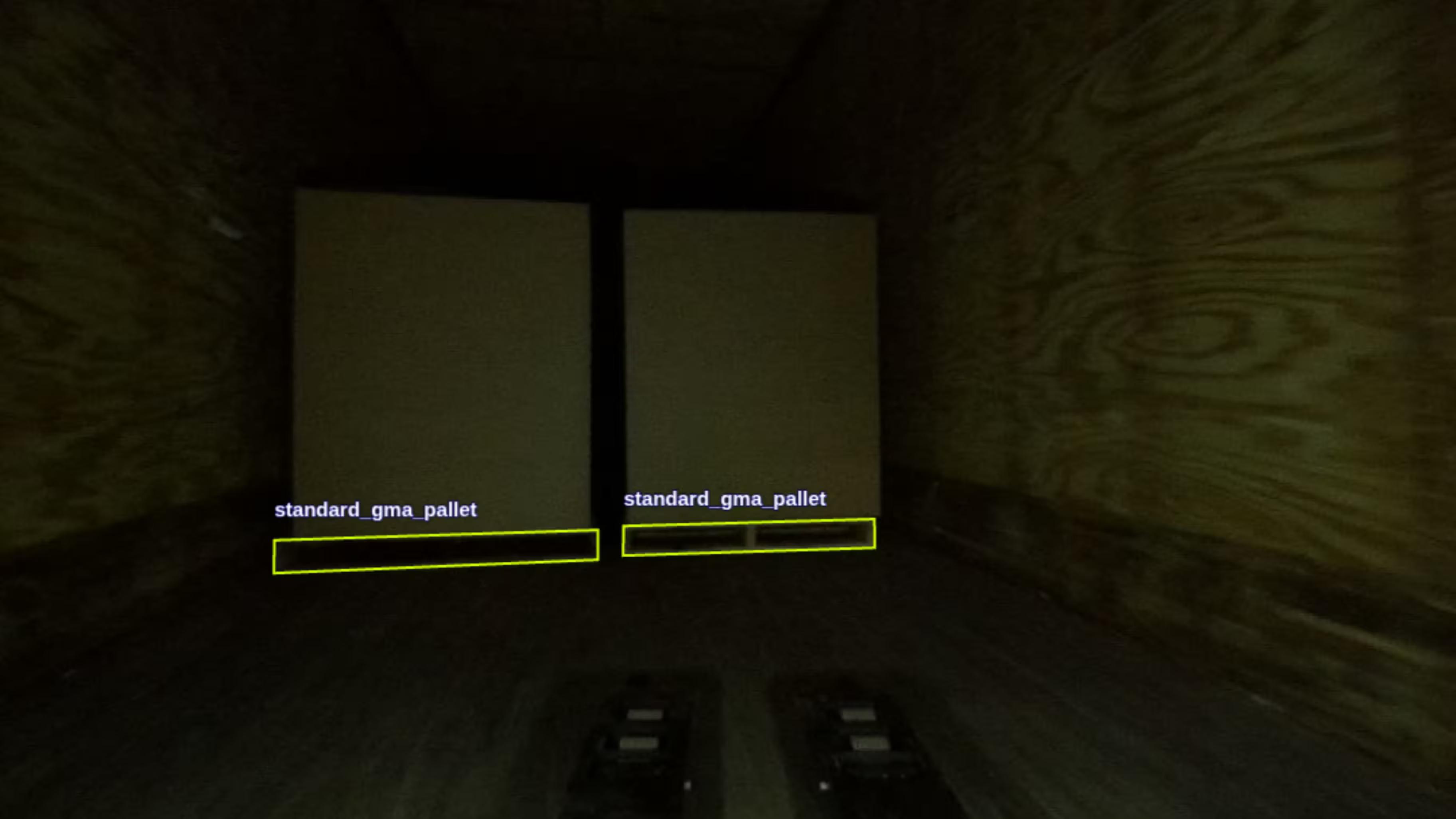 The view from a robot camera inside a dimly lit trailer, two pallets detected and labeled standard_gma_pallet.