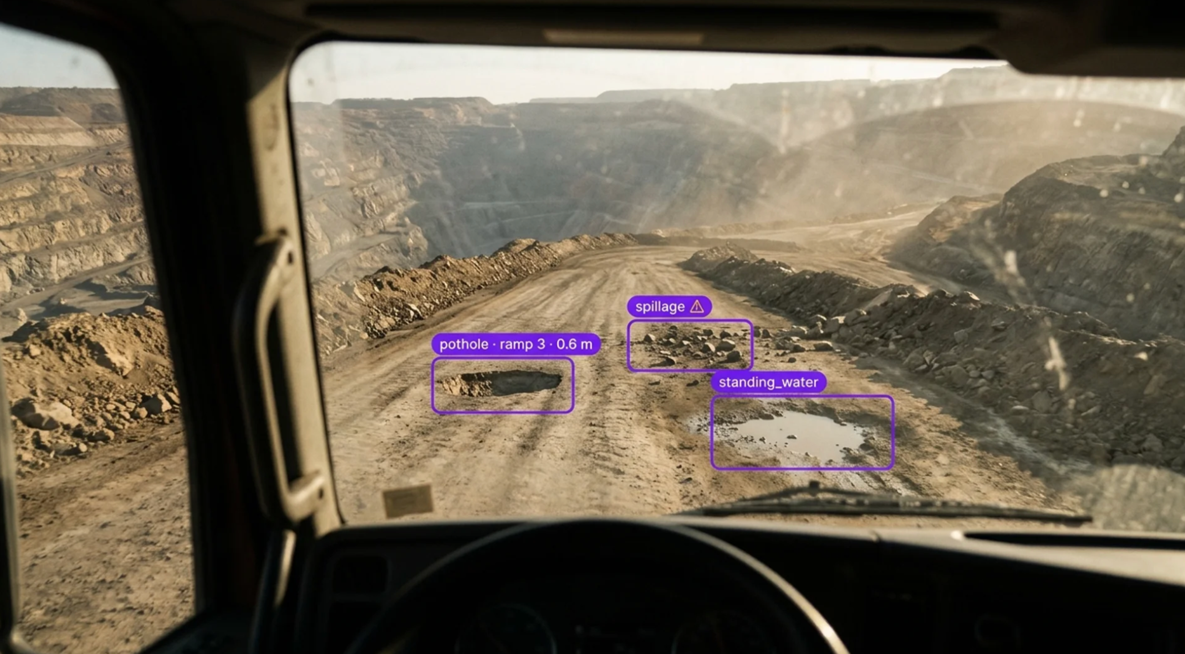 AI identifies road hazards (pothole, spillage, standing water) on a dirt road within an open-pit mine, viewed from a vehicle.