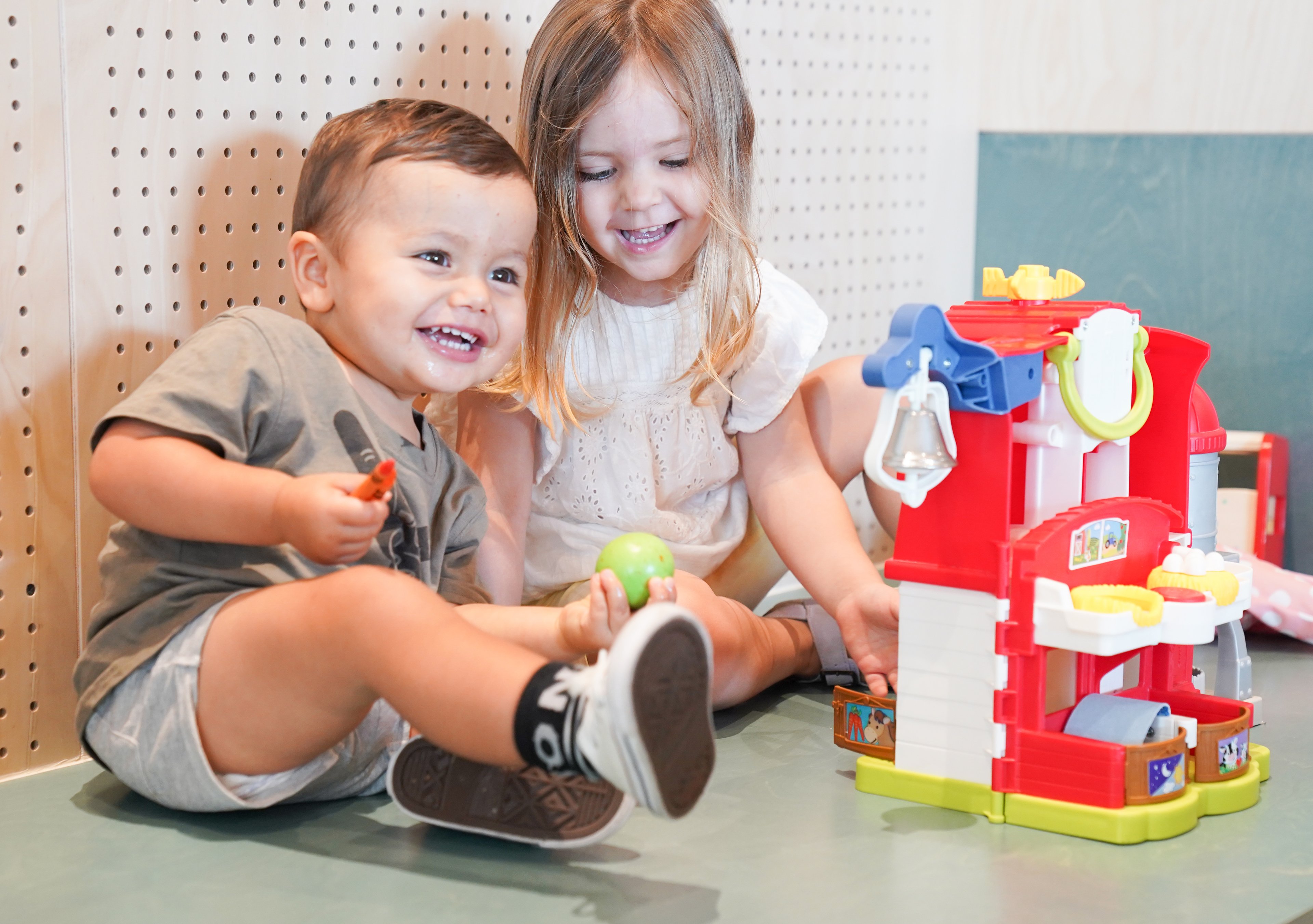 Two children playing inside the creche at Gunyama Park