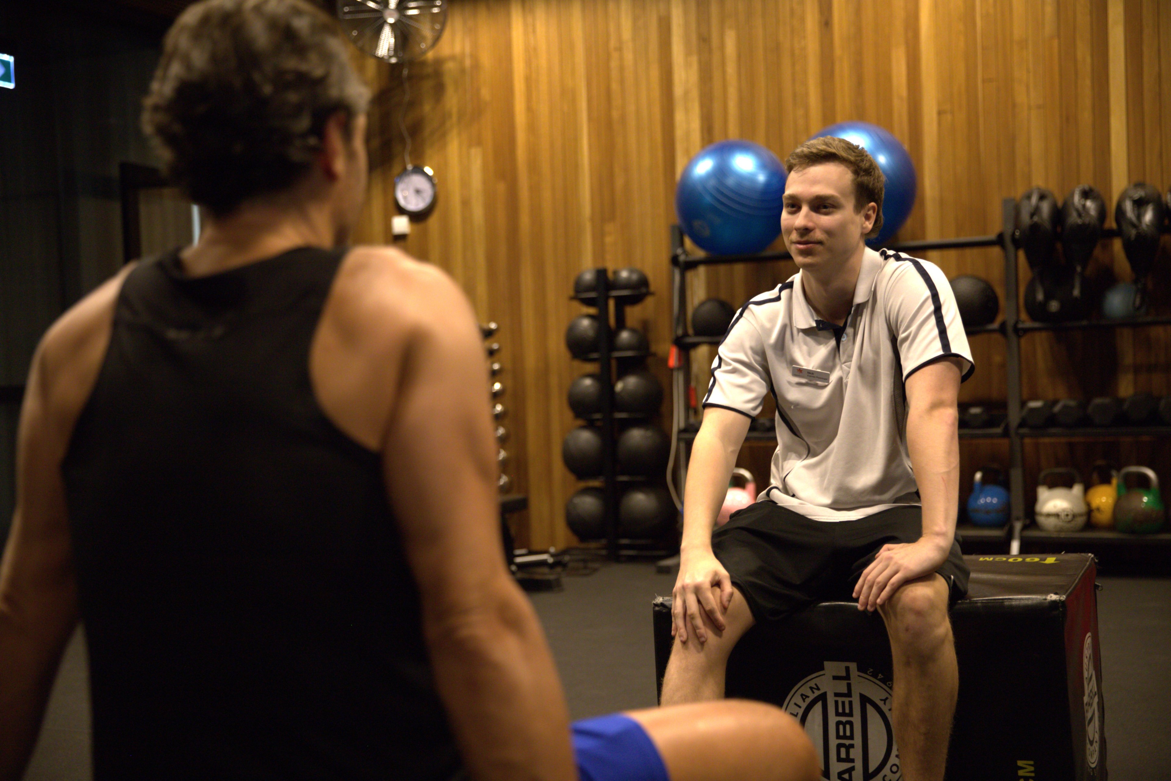 Exercise Physiologist Nick talking with a client during an EP session at Gunyama Park