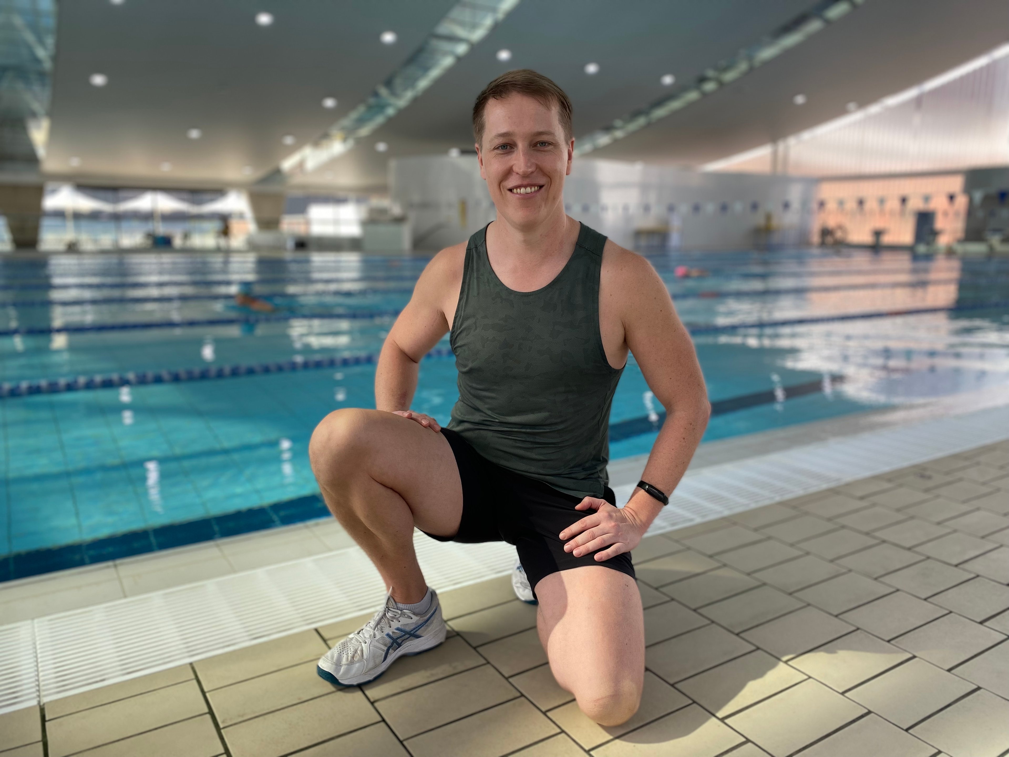 Instructor Rob in front of the indoor pool at at Ian Thorpe Aquatic Centre