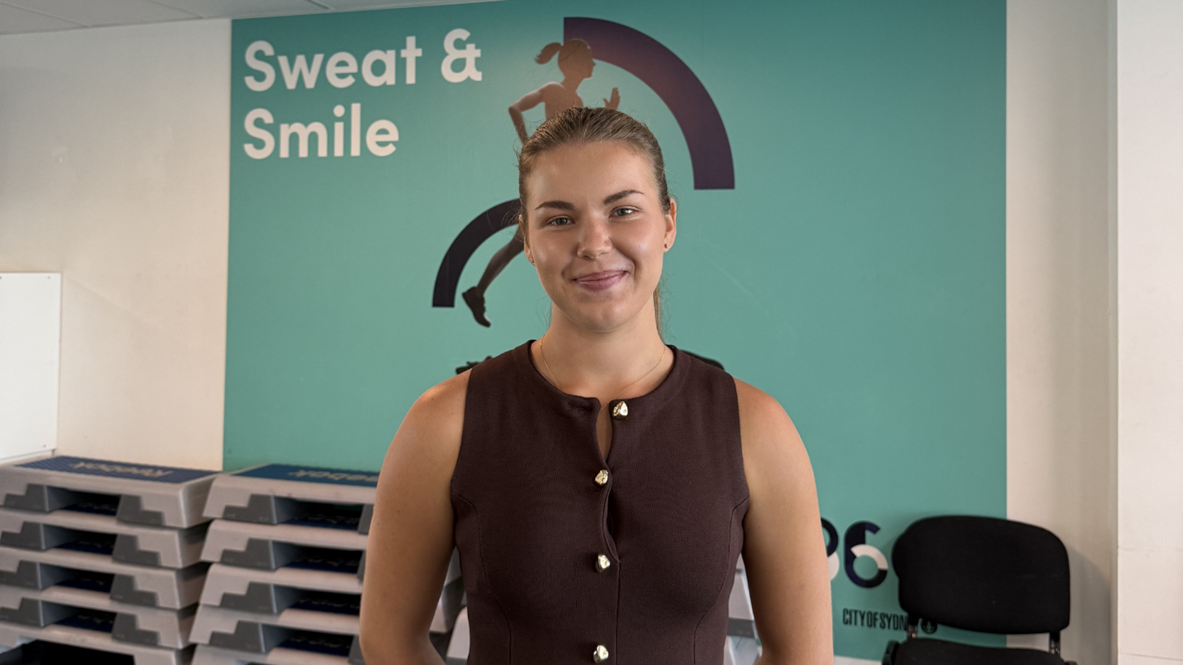 Khrystyna smiling inside the fitness studio at Ian Thorpe Aquatic Centre 