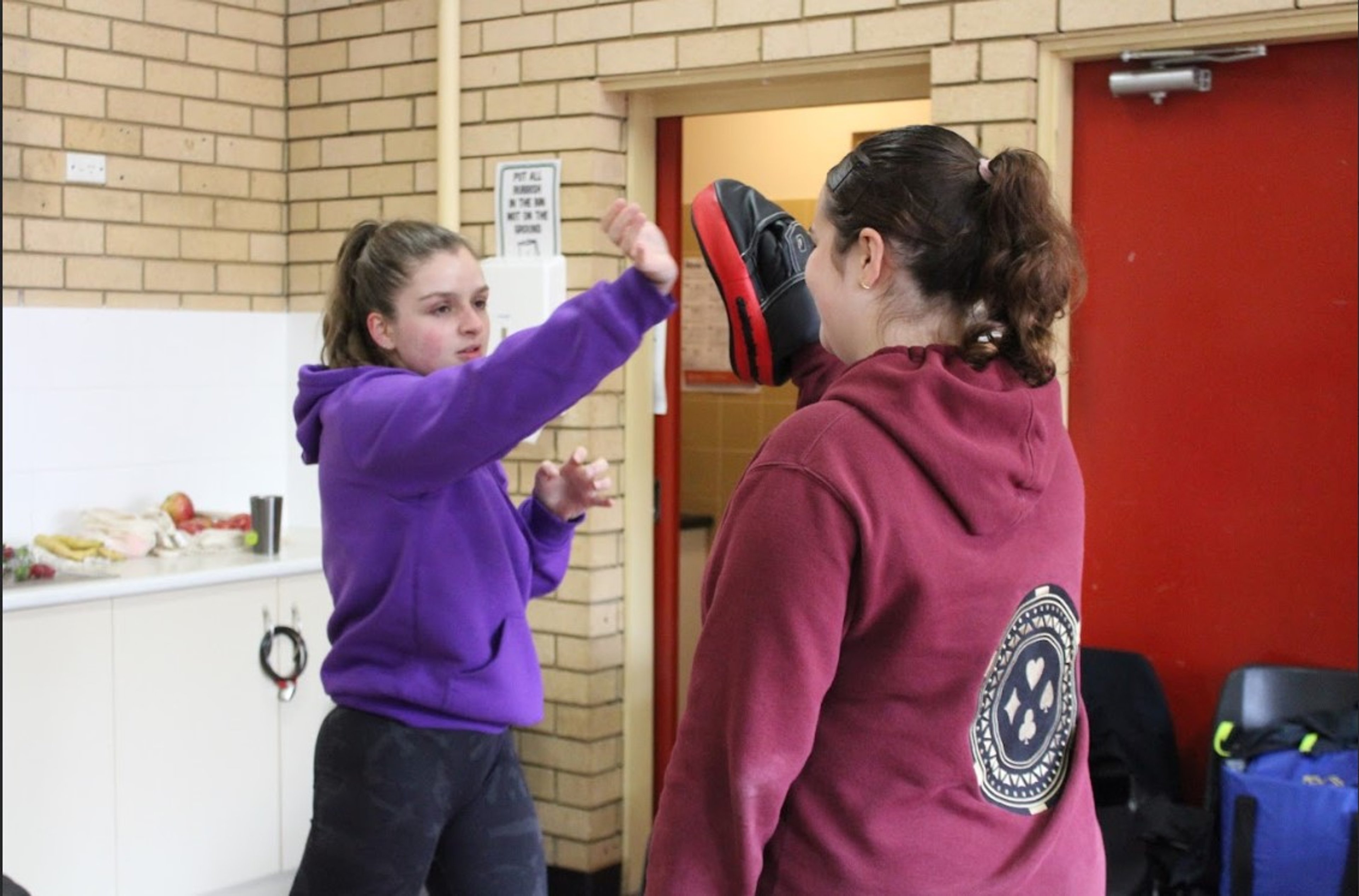 Women practicing defence skills during a self-defence class 