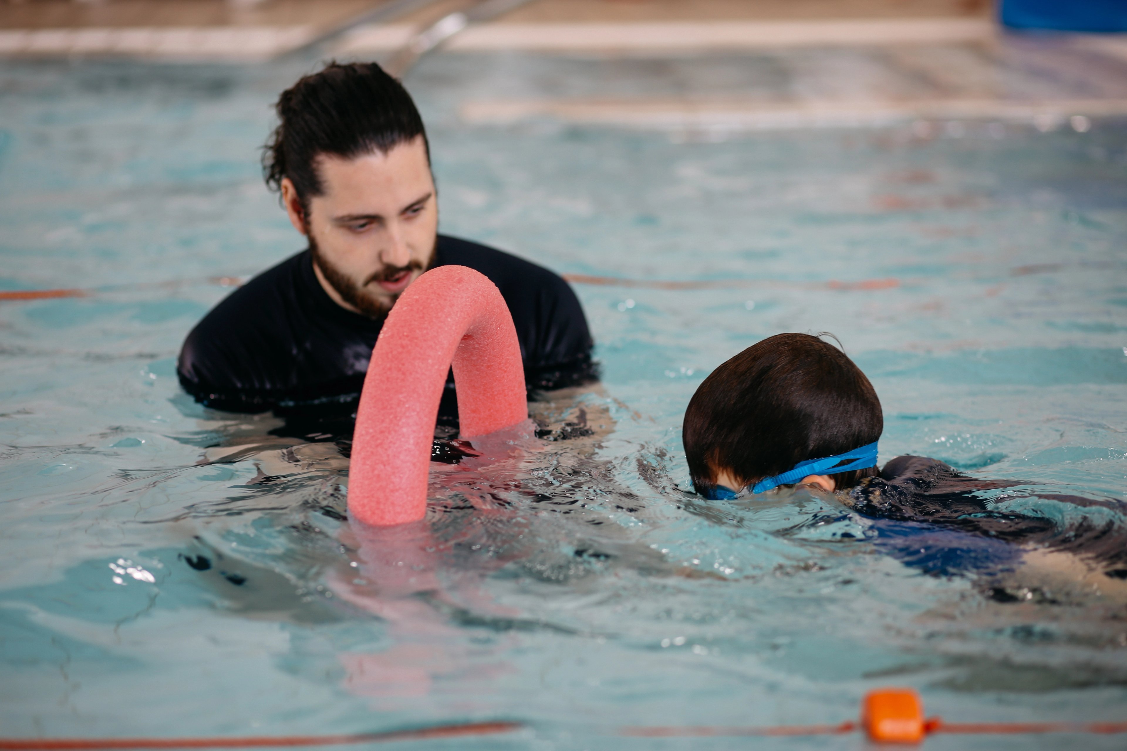Swim teacher instructing a child during a learn to swim lesson at Ian Thorpe Aquatic Centre