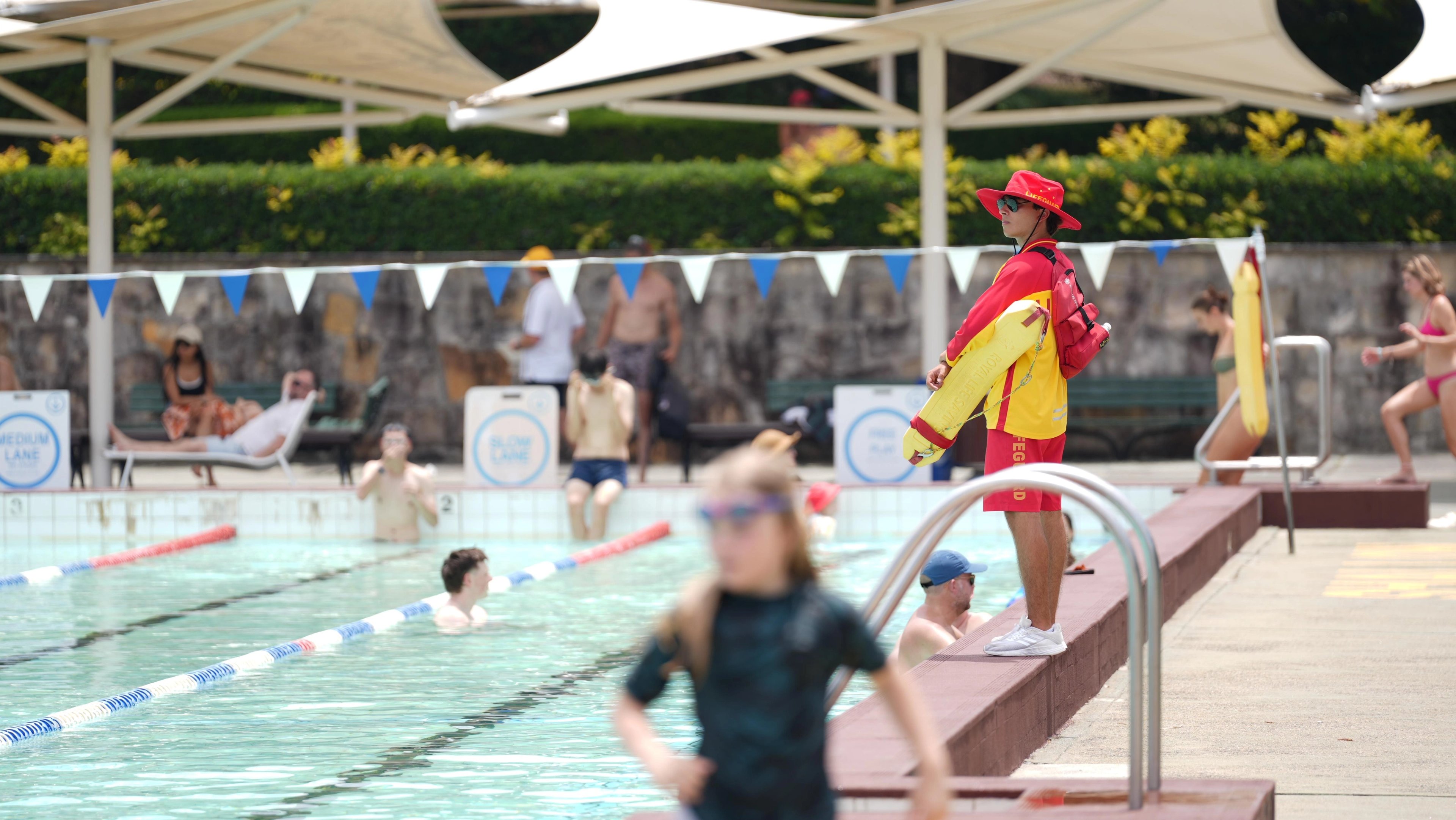 A lifeguard watches over swimmers in the outdoor pool at Victoria Park Pool.
