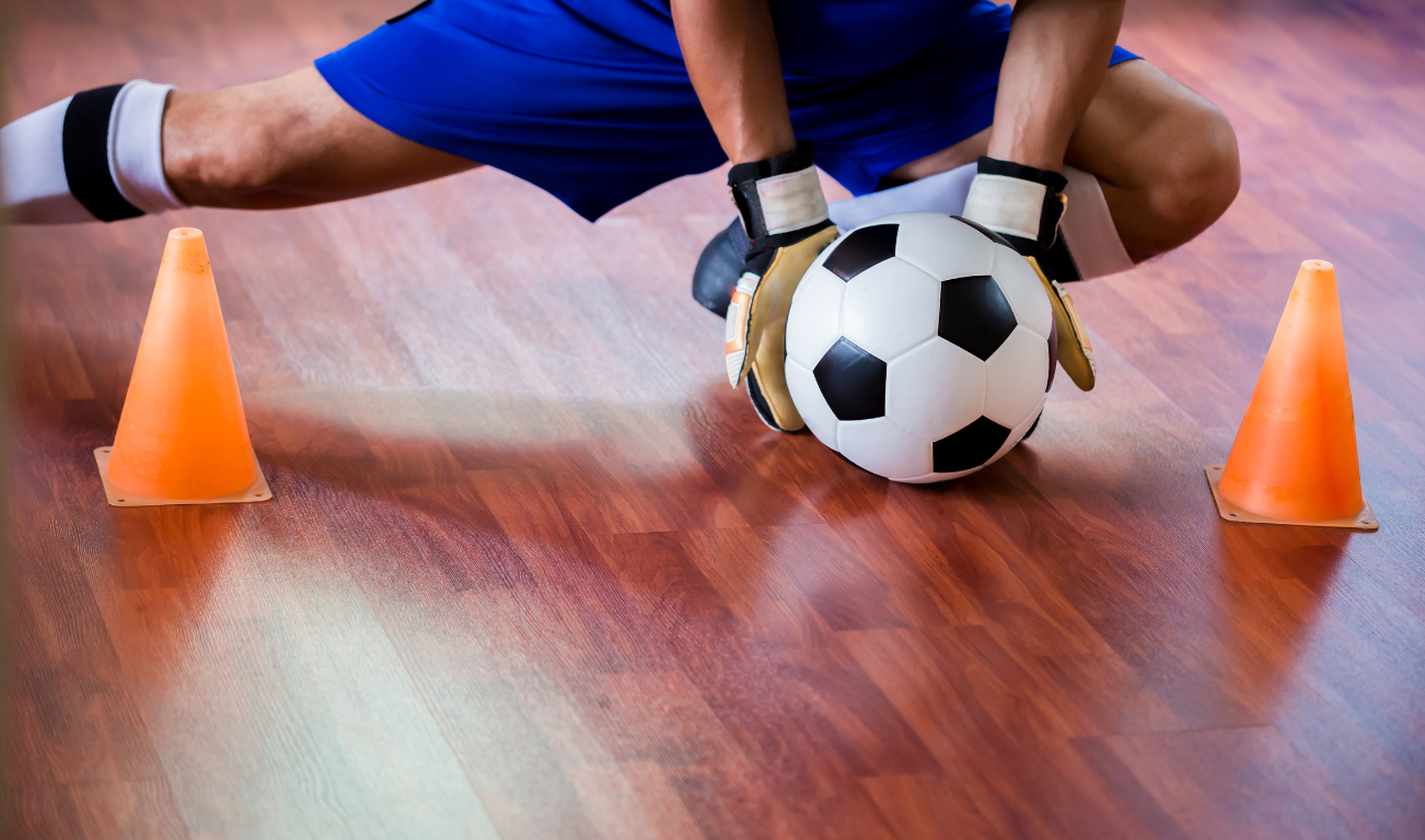 Man catching a ball during a game of futsal