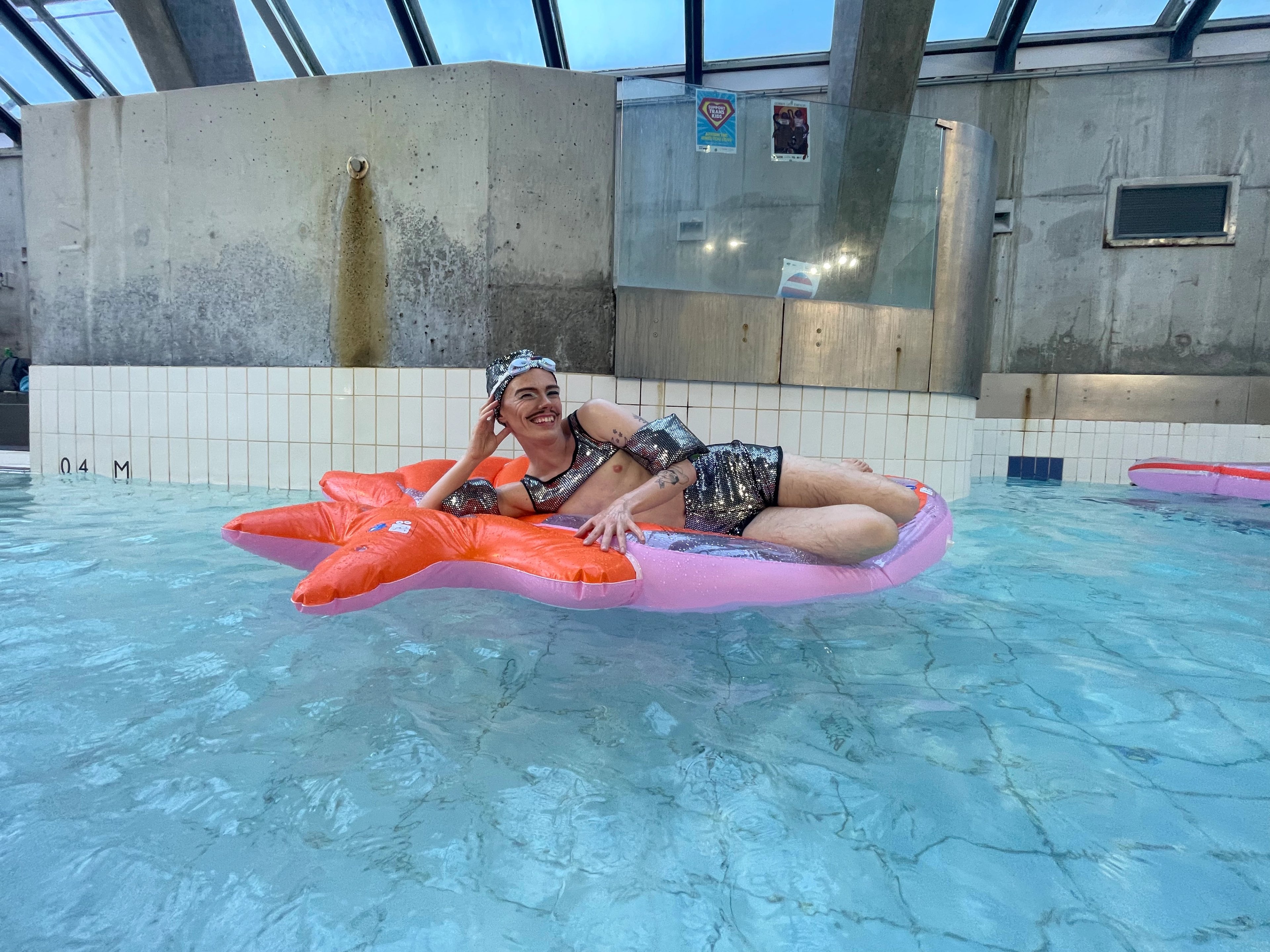 Woody on a floaty in the indoor pool at Cook + Phillip Park Pool