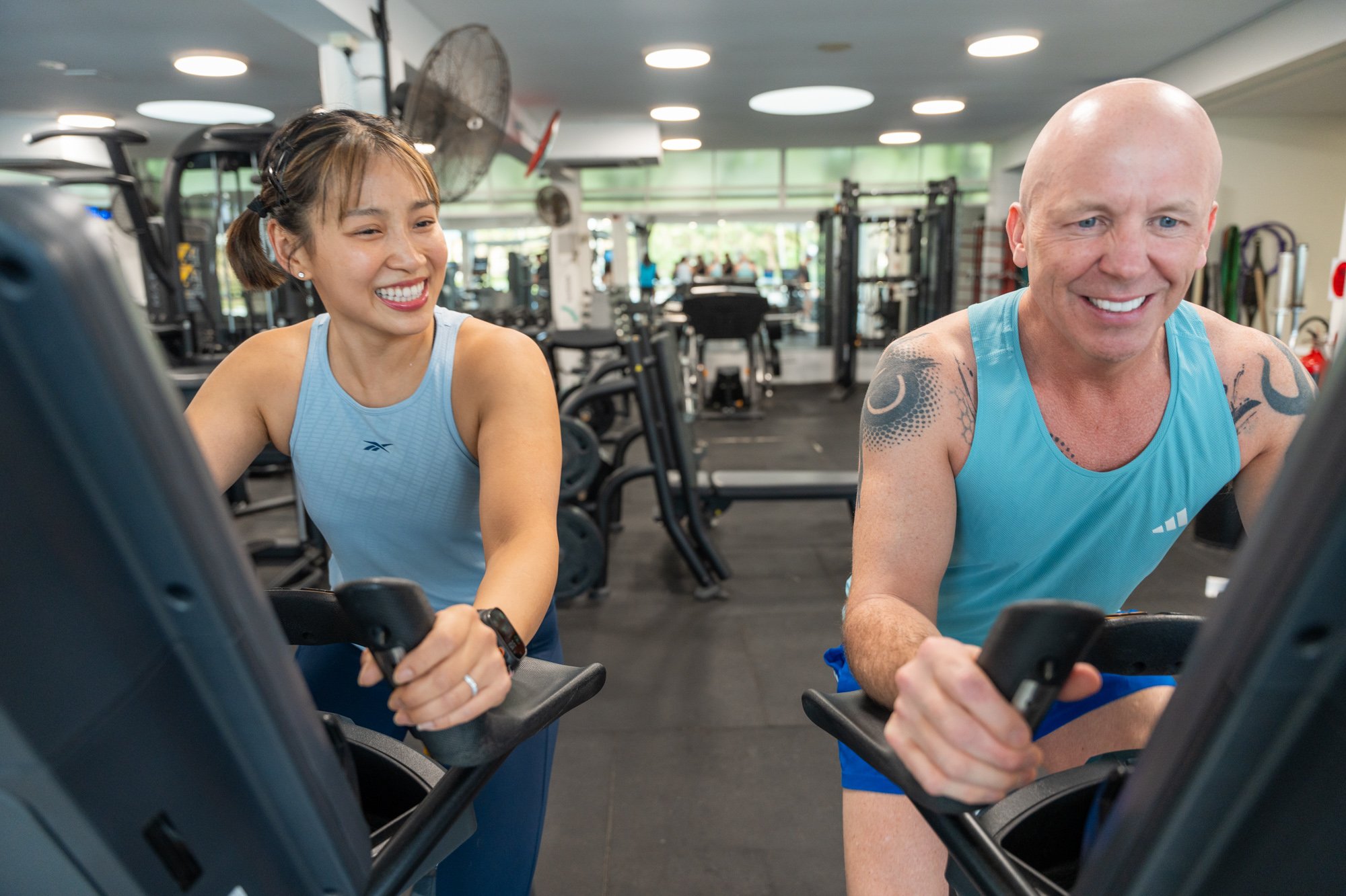 Woman and man on the exercise bikes at Victoria Park Pool gym
