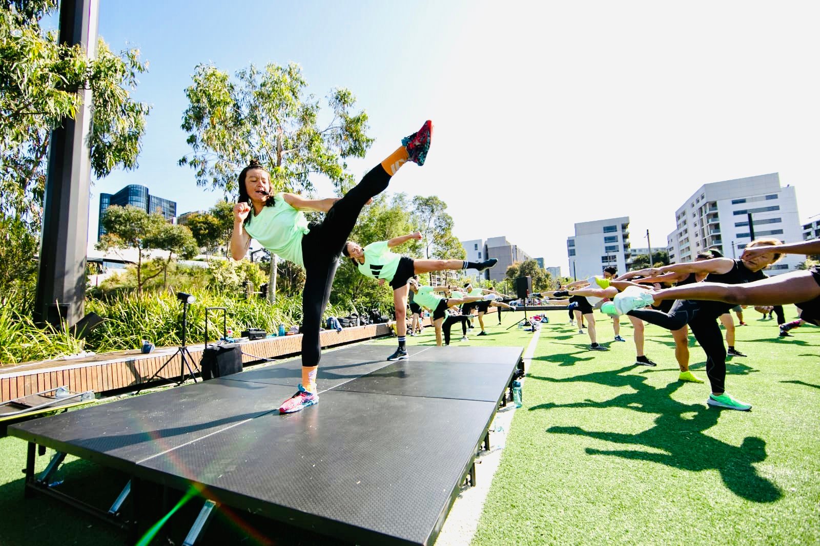 Fitness instructor Linda instructing a BodyCombat class on stage