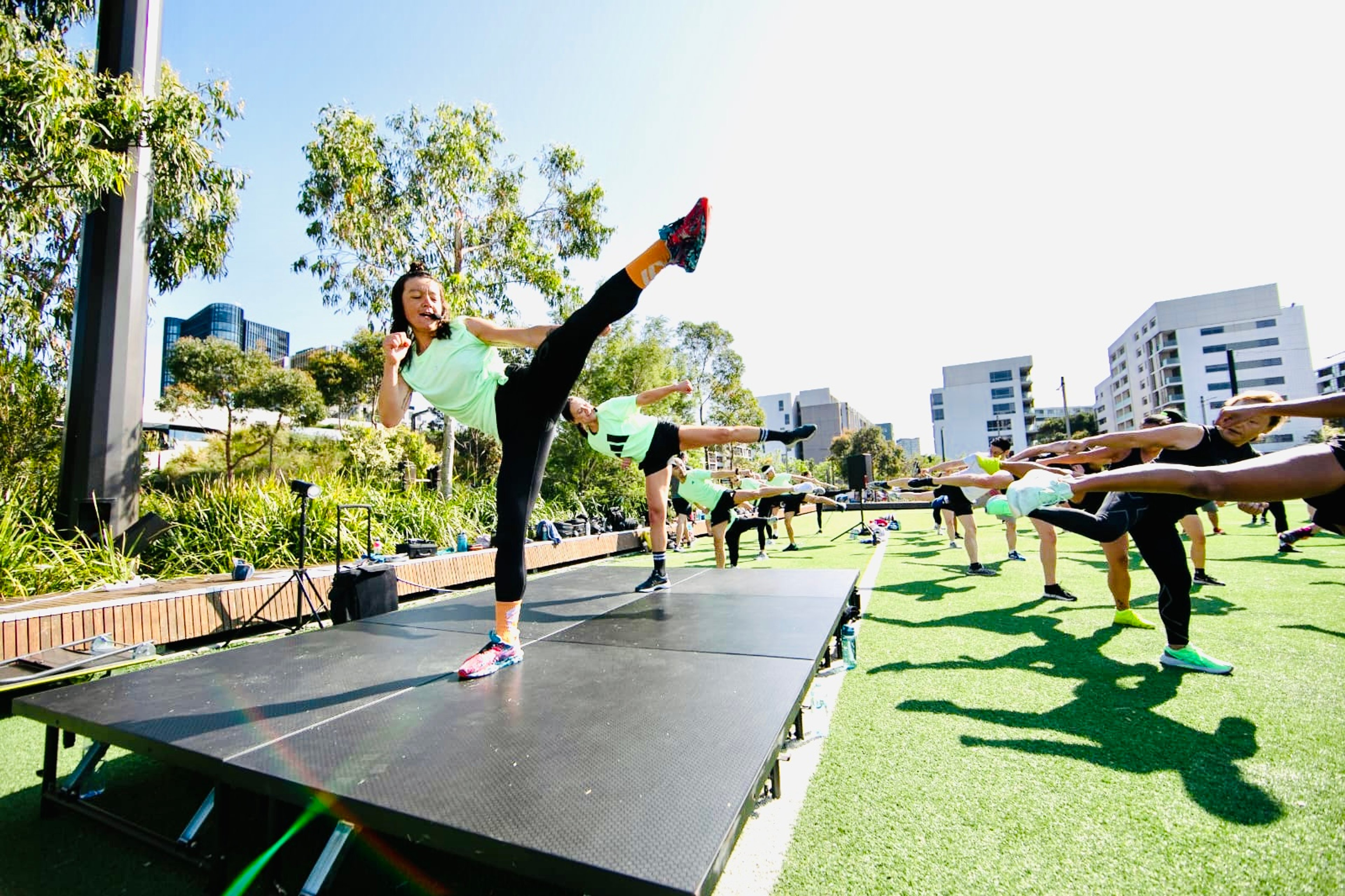 Fitness instructor Linda instructing a BodyCombat class on stage 