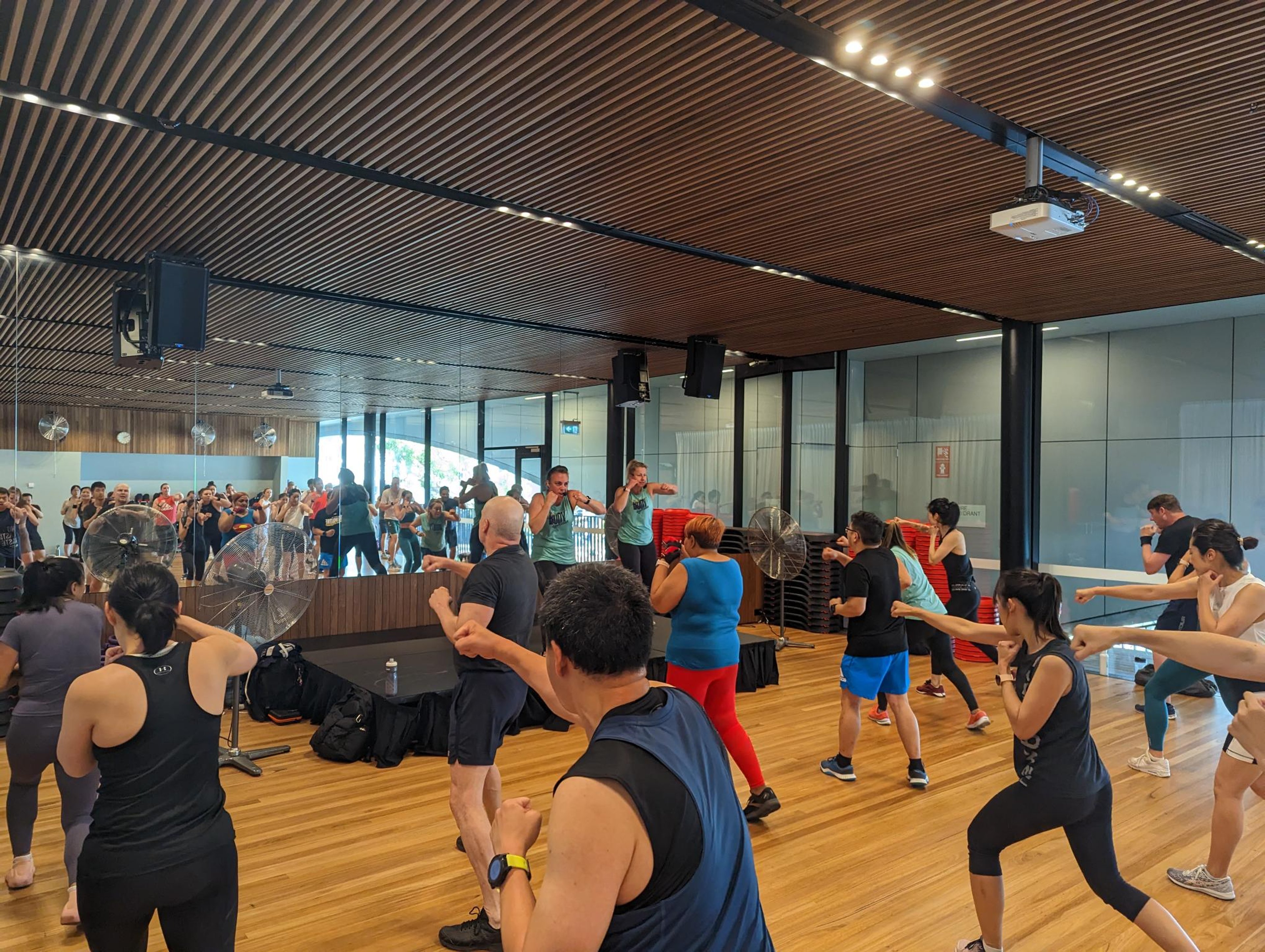 A BODYCOMBAT100 class taking place inside Gunyama Park fitness studio