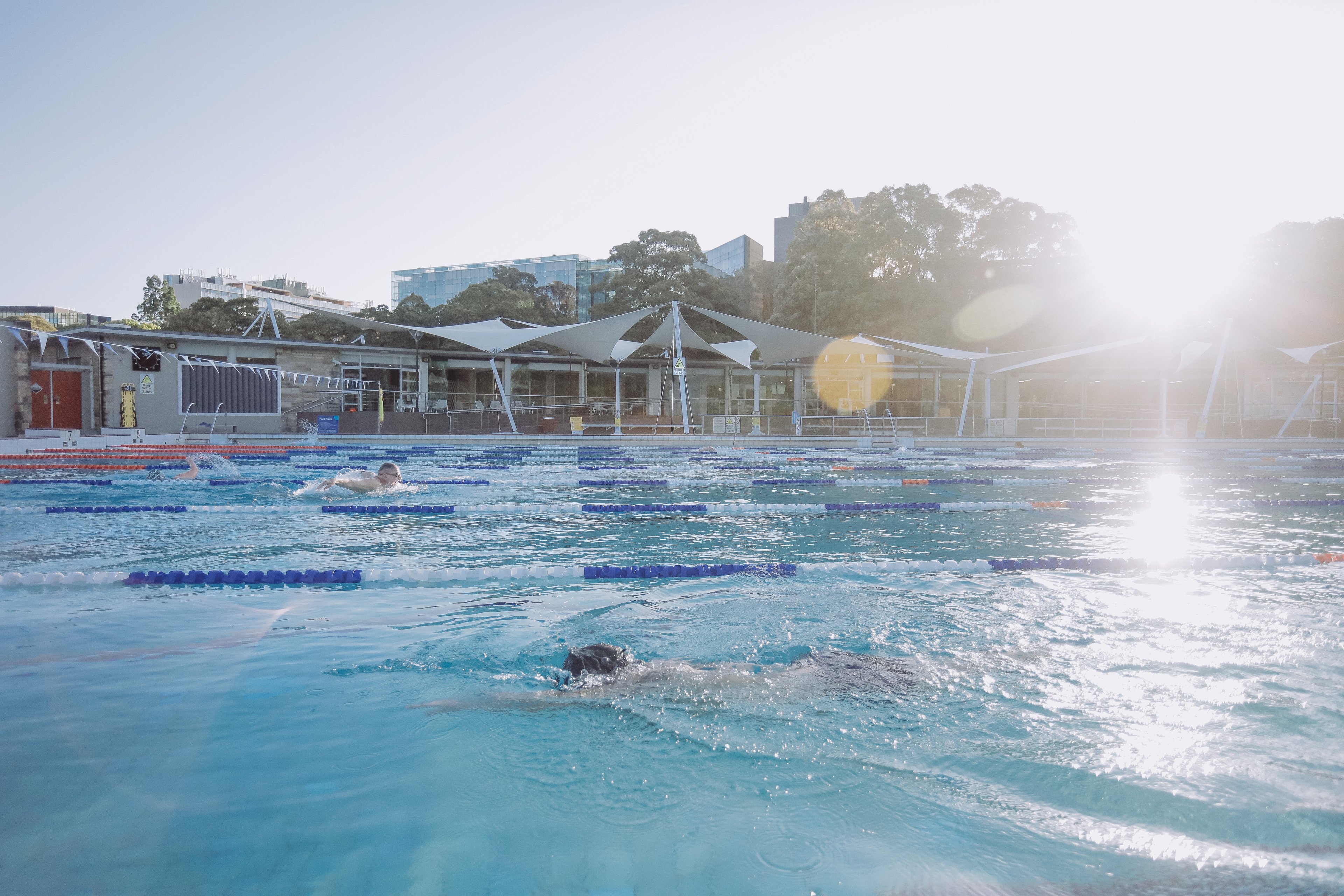 Sun shining over the 50m pool at Victoria Park Pool