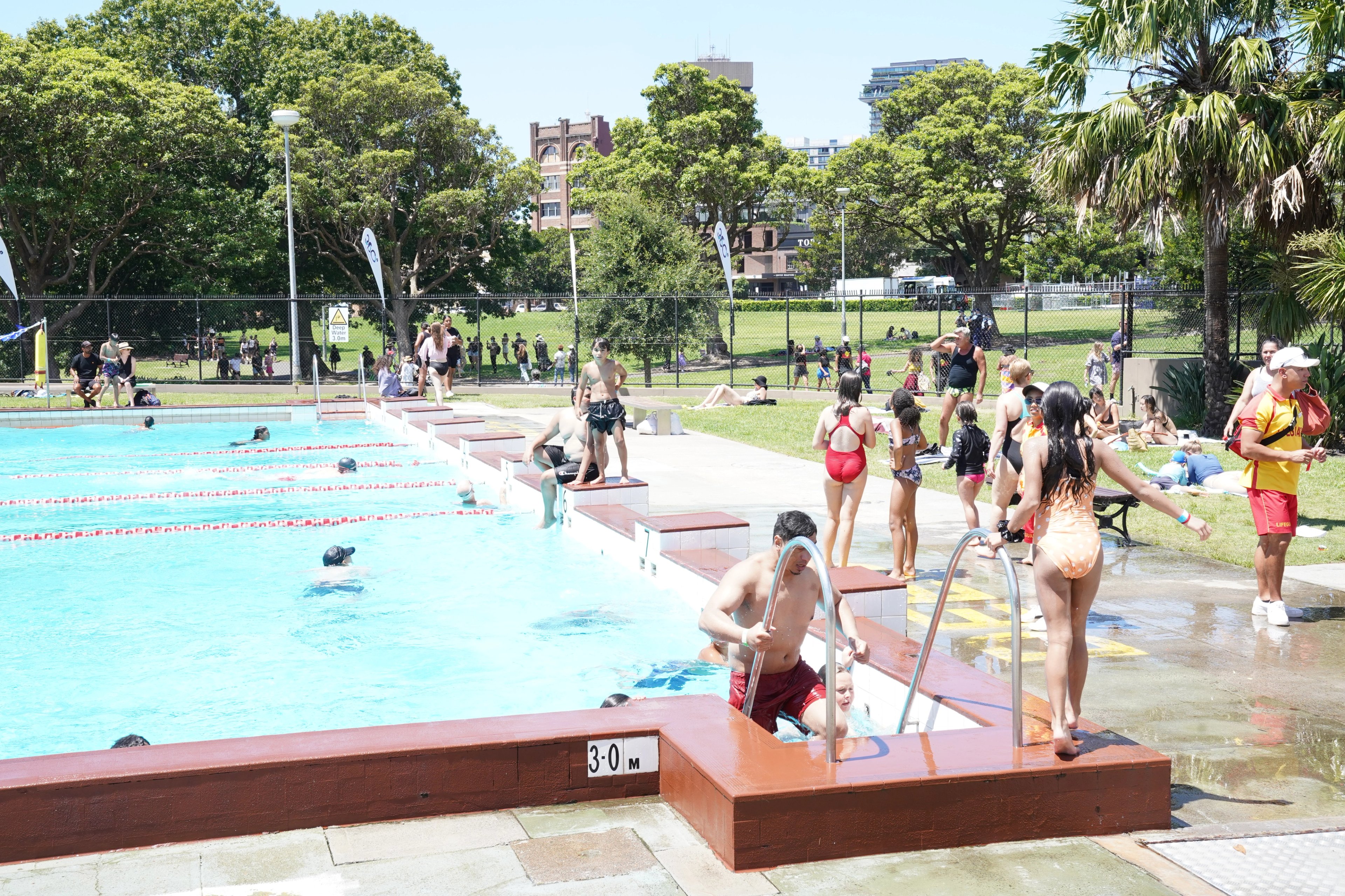 People using the outdoor pool at Victoria Park Pool on a sunny day