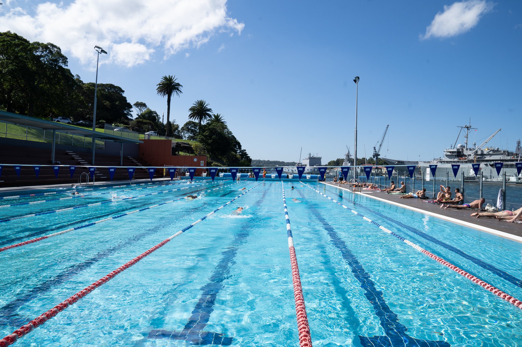 People swimming and relaxing at Andrew (Boy) Charlton Pool