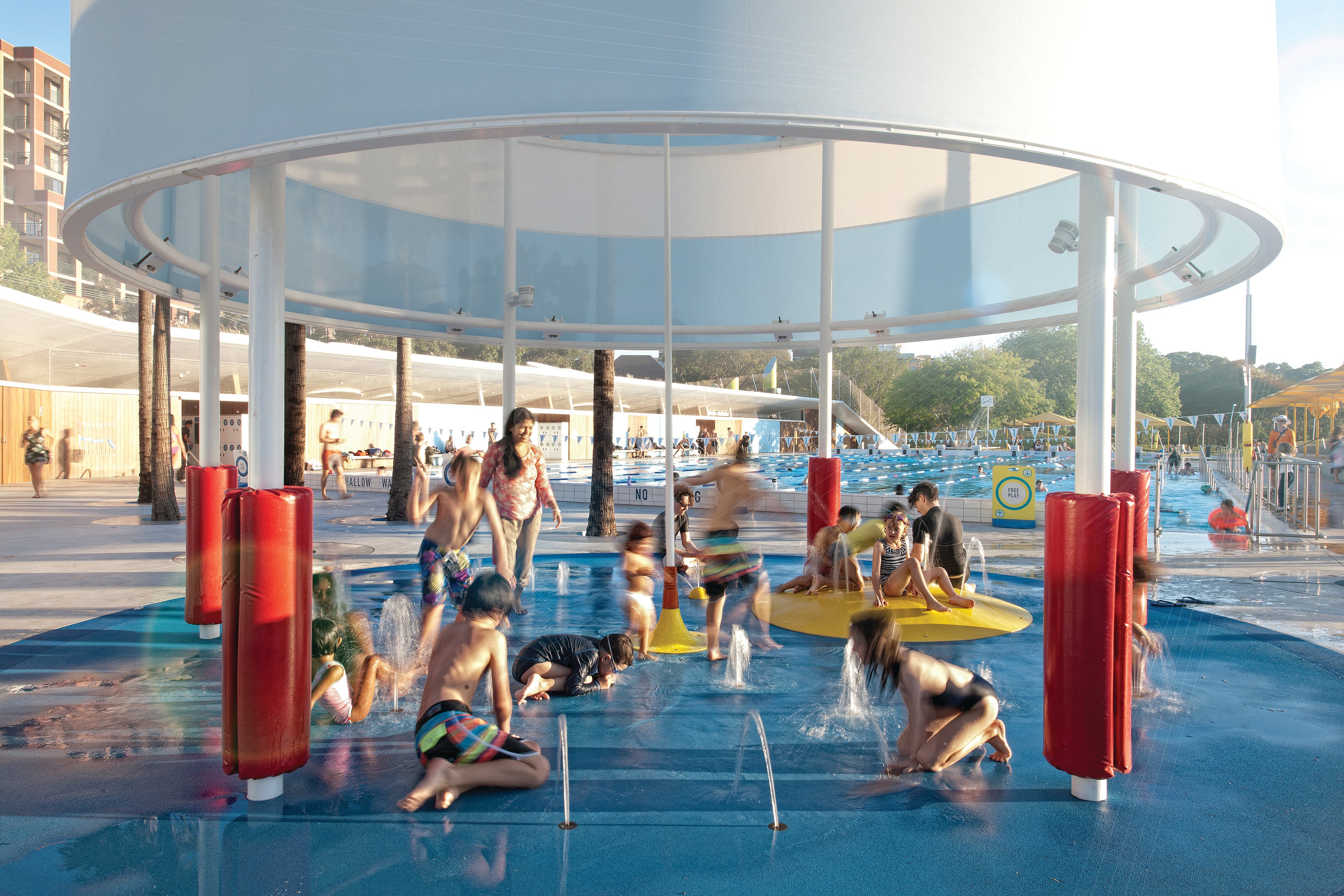 Children playing in the splash pad with water fountains at Prince Alfred Park Pool