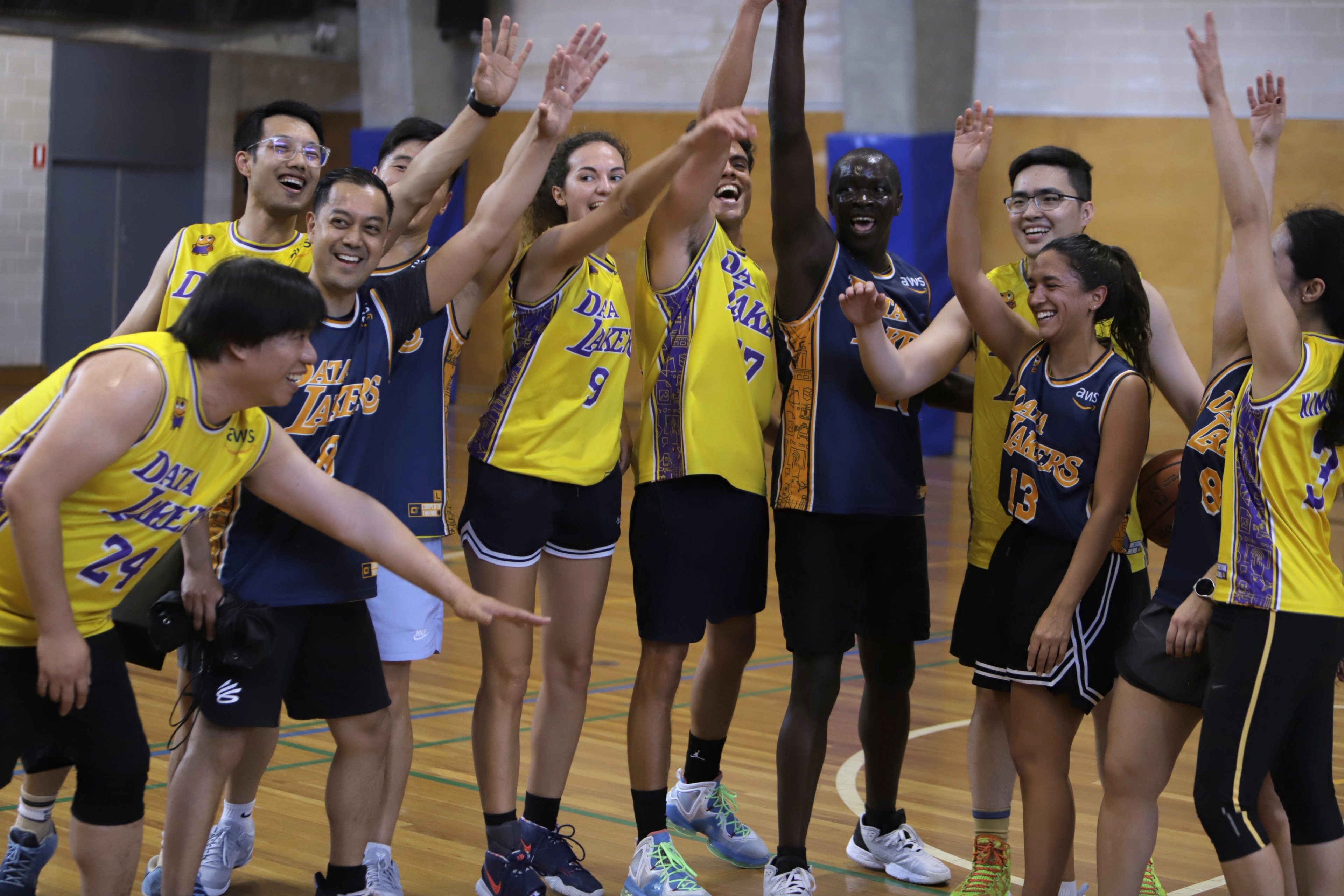 Group of basketball players celebrating on the sports court at Cook + Phillip Park Pool