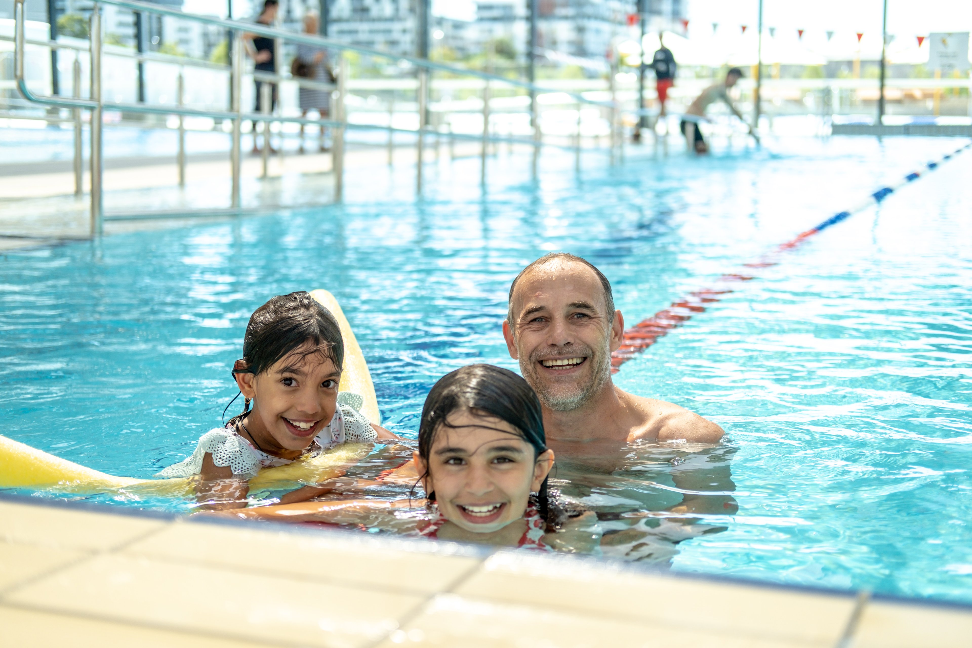 A father and two kids in the pool at Gunyama Park