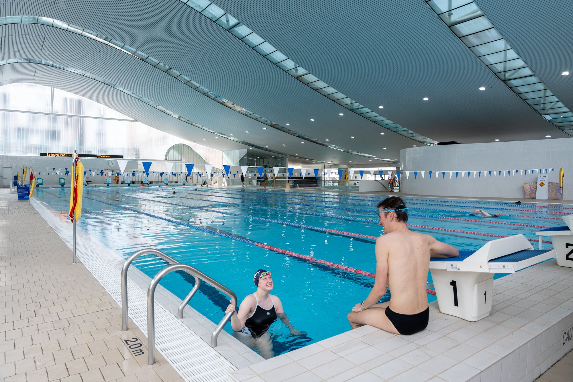 Male and female in the pool talking at Ian Thorpe Aquatic Centre
