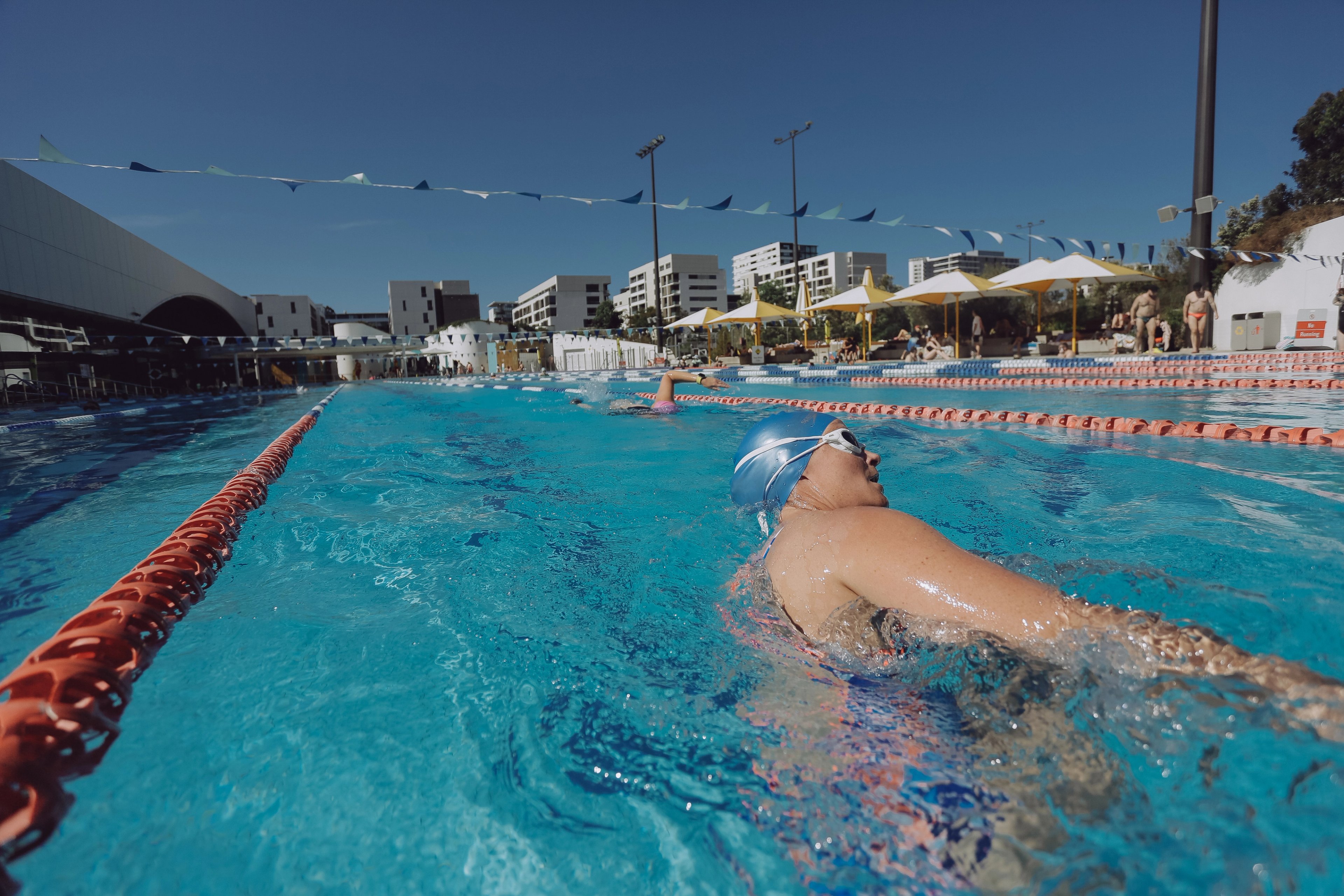 Woman swimming laps in the outdoor 50m pool at Gunyama Park 