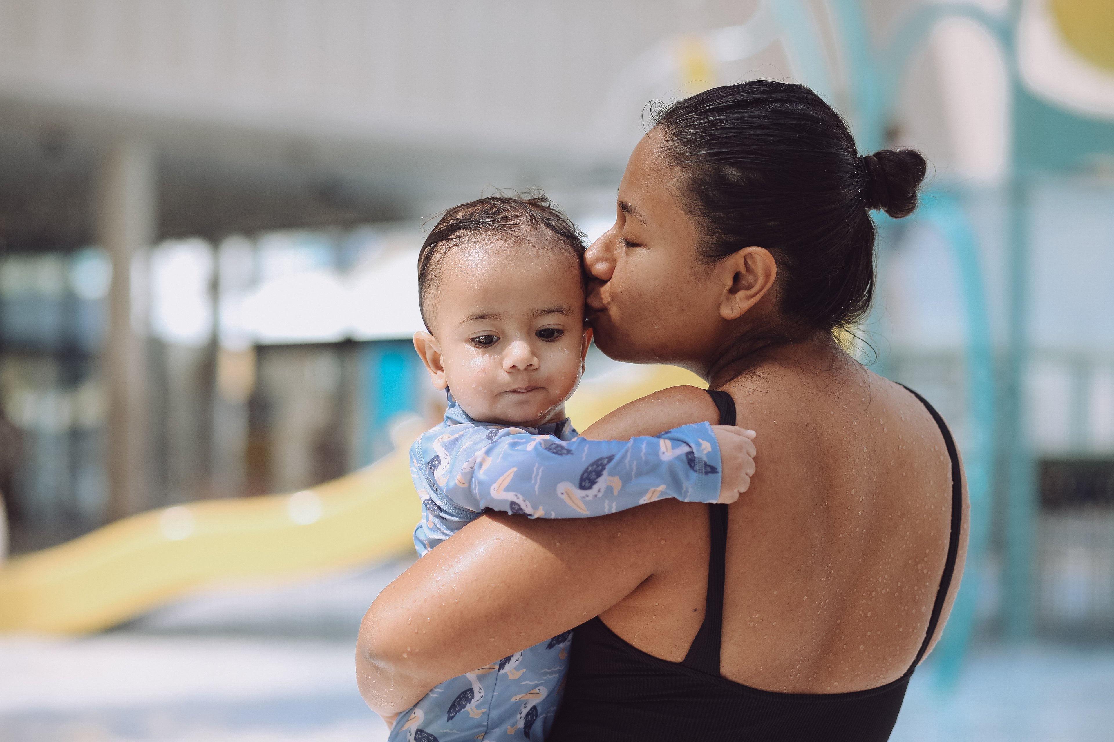 Mum kissing her baby on the head at Gunyama Park centre 