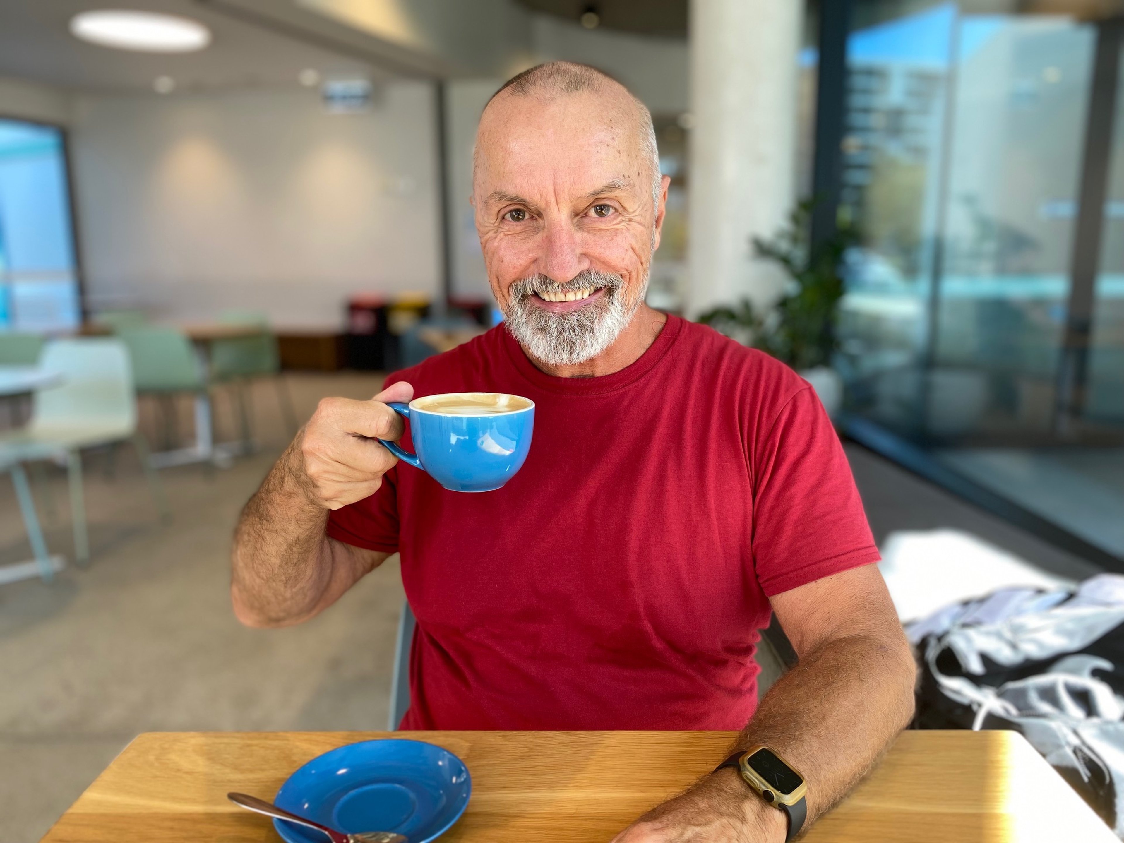 360 member Grant in his happy place having coffee at Gunyama Park Cafe at Gunyama Park Aquatic and Recreation Centre