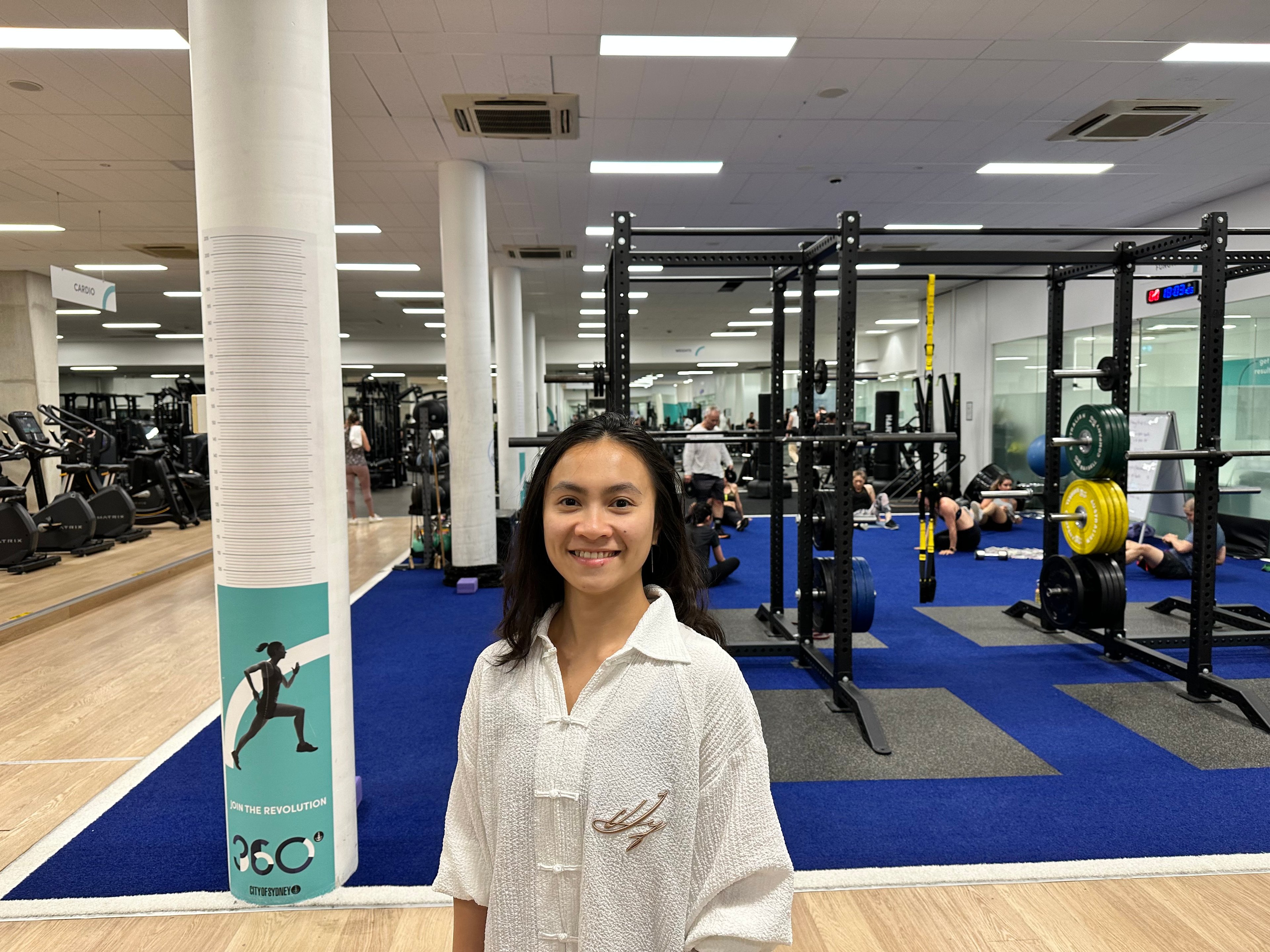 Yoga instructor Chau smiling inside the fitness centre at Ian Thorpe Aquatic Centre