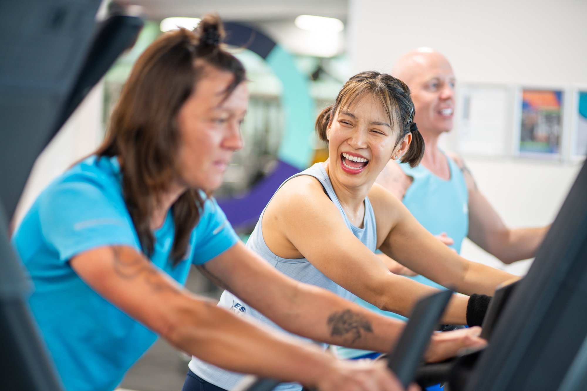 Three people on exercise bikes in the gym at Victoria Park Pool