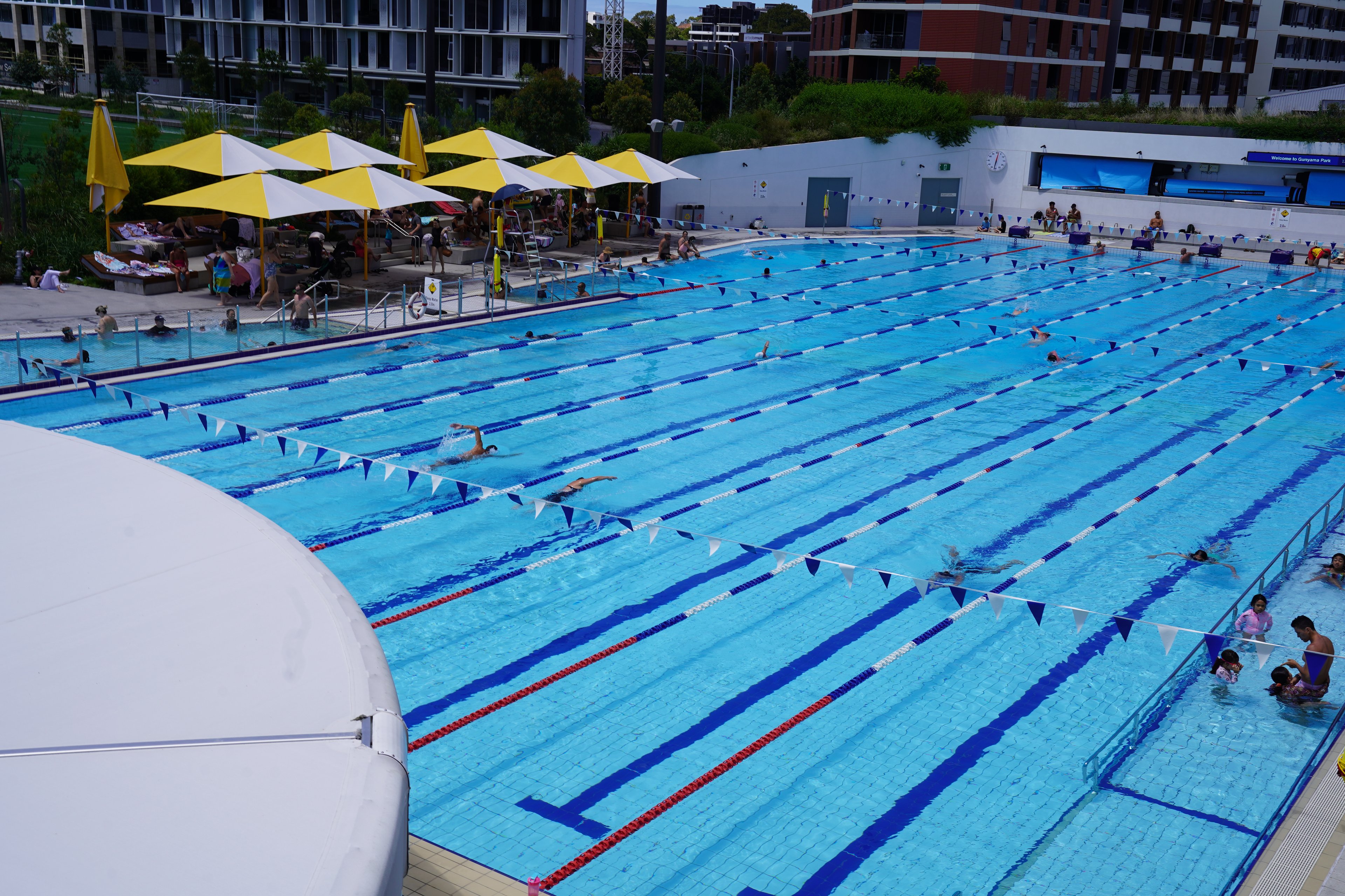 People swimming in the outdoor heated 50m pool at Gunyama Park