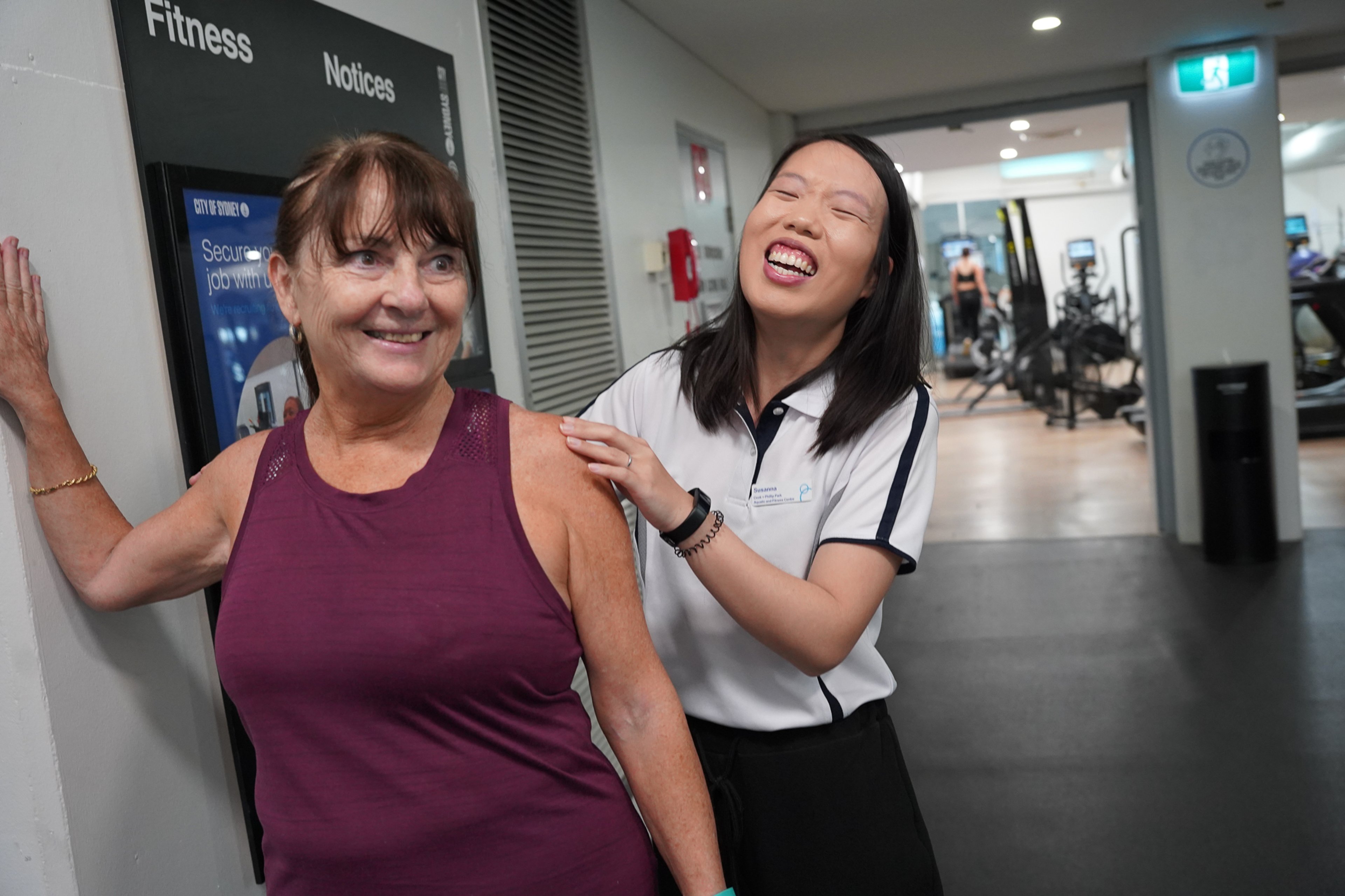 Exercise physiologist supports a participant in the fitness centre at Cook + Phillip Park Pool