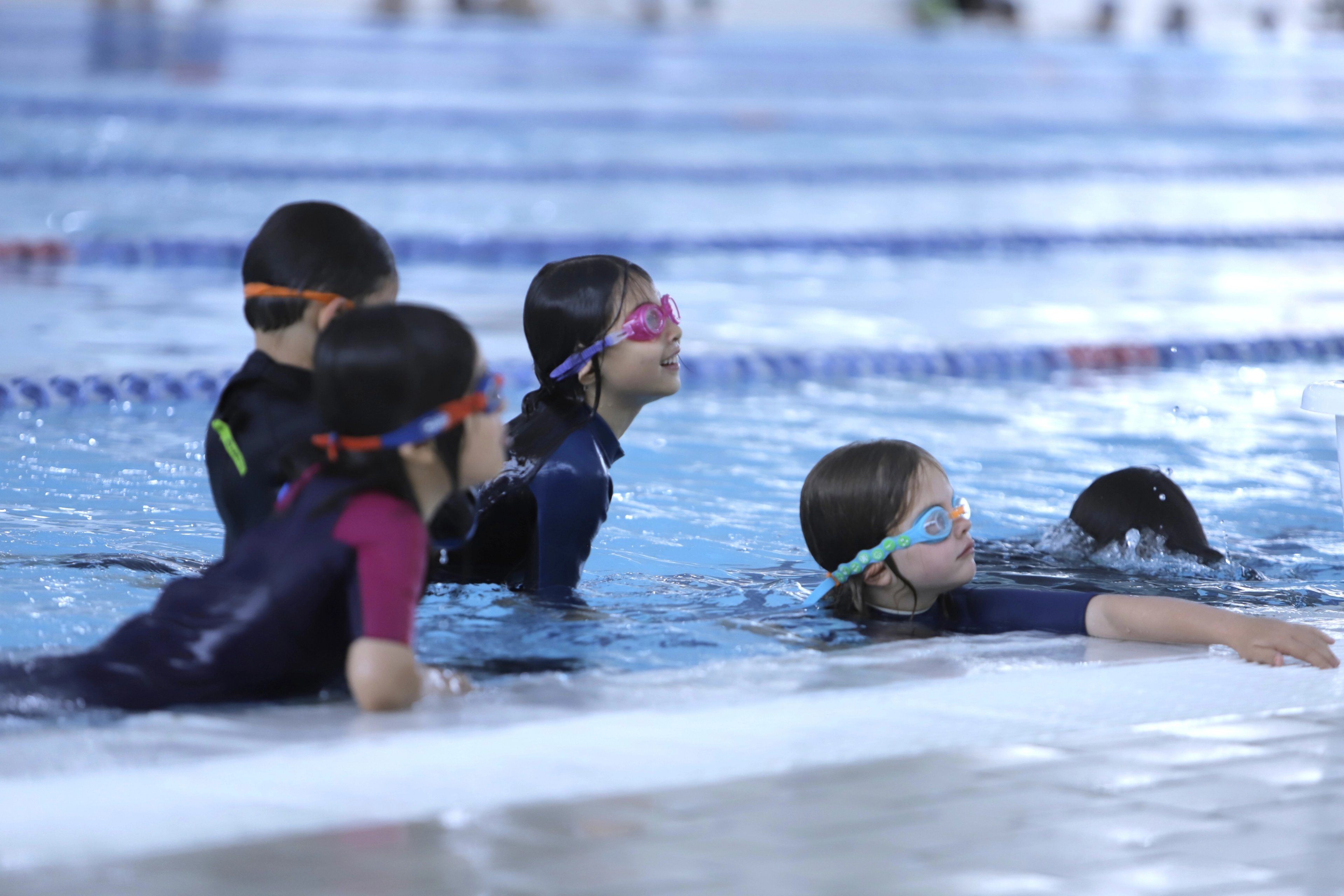 A group of children during a learn to swim class in the pool at Ian Thorpe Aquatic Centre 