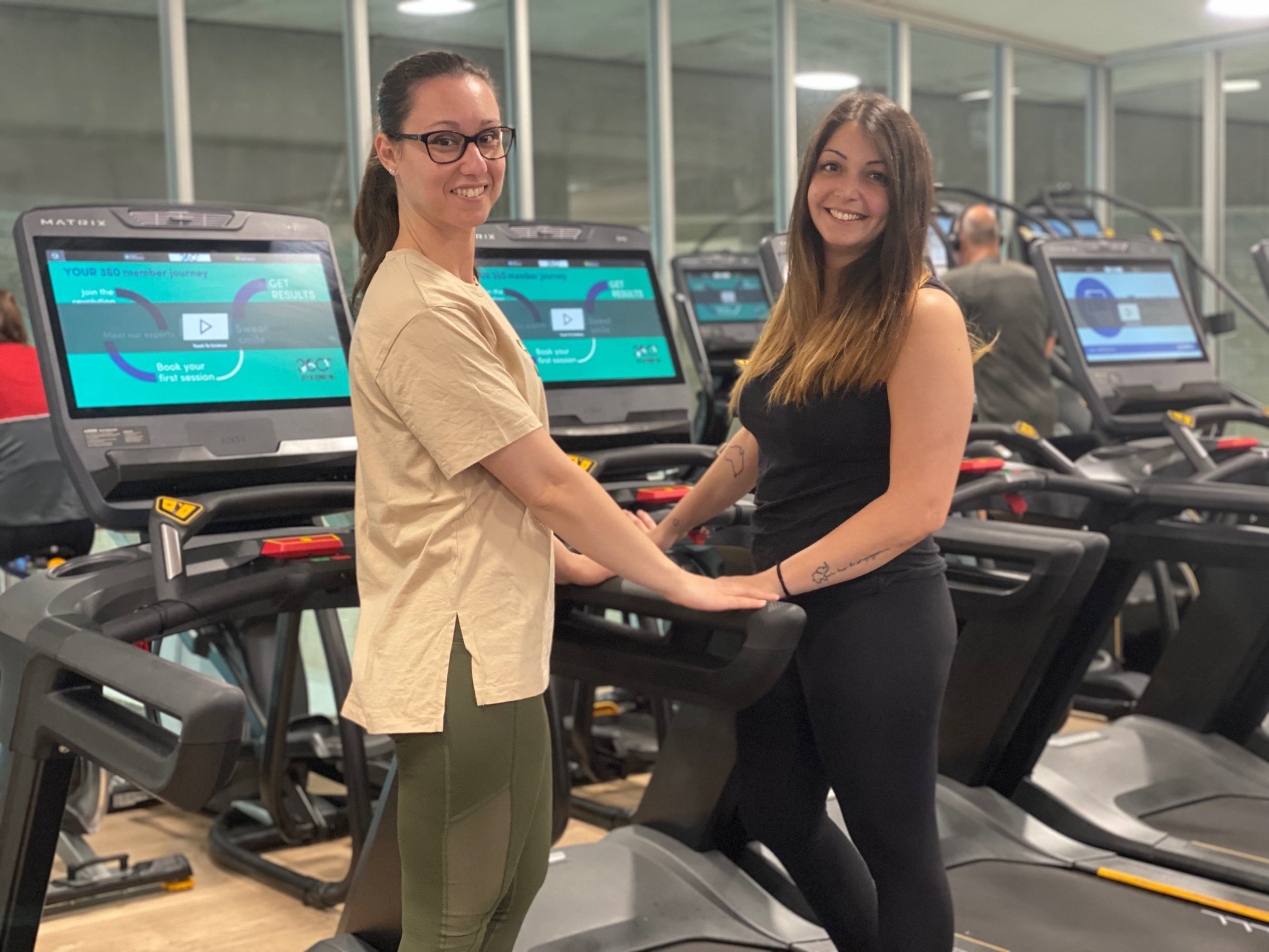 360 members Illyria and Chiara holding hands in their happy place at Cook + Phillip Park Pool