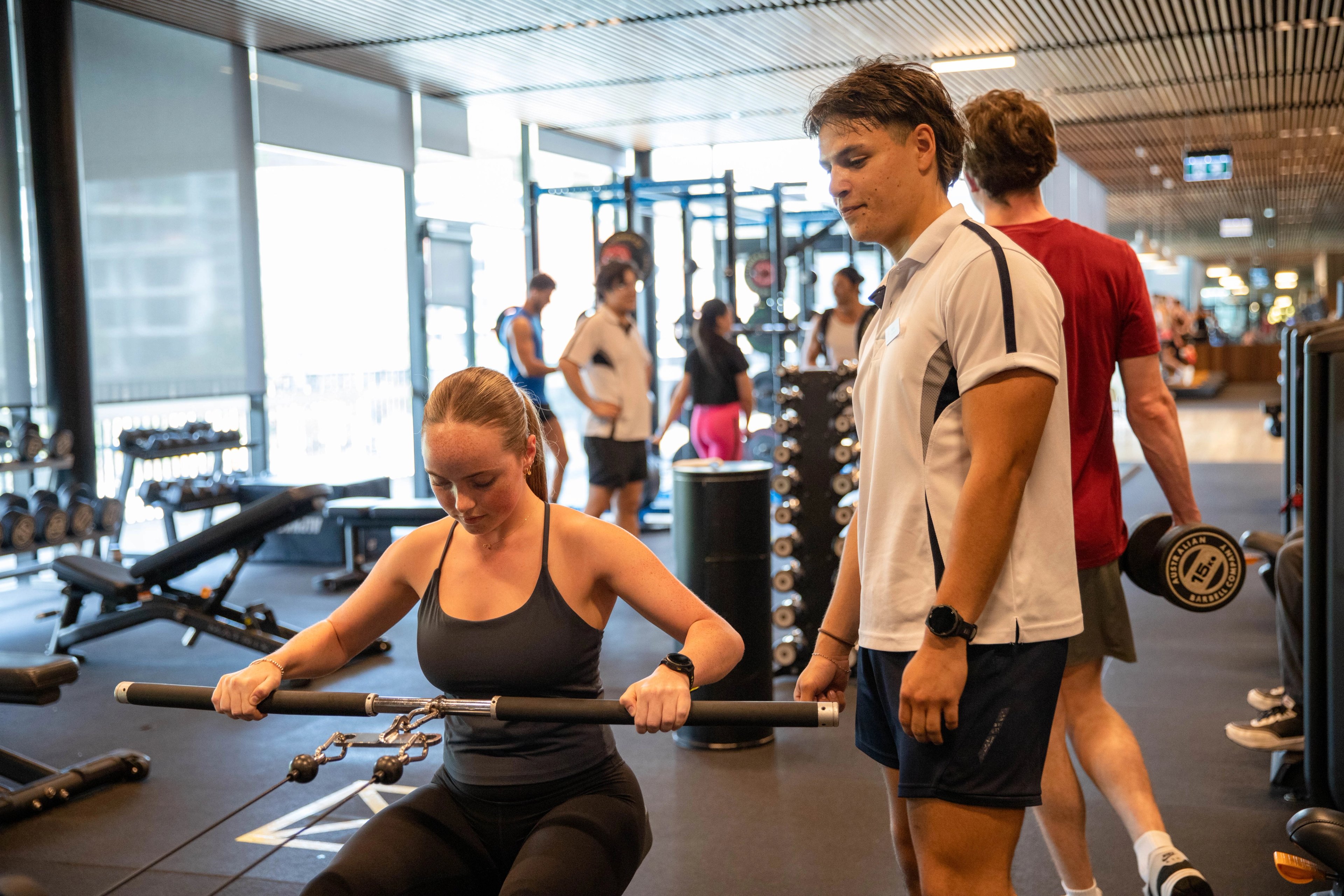 A client being assisted by a personal trainer in the gym at Gunyama Park 