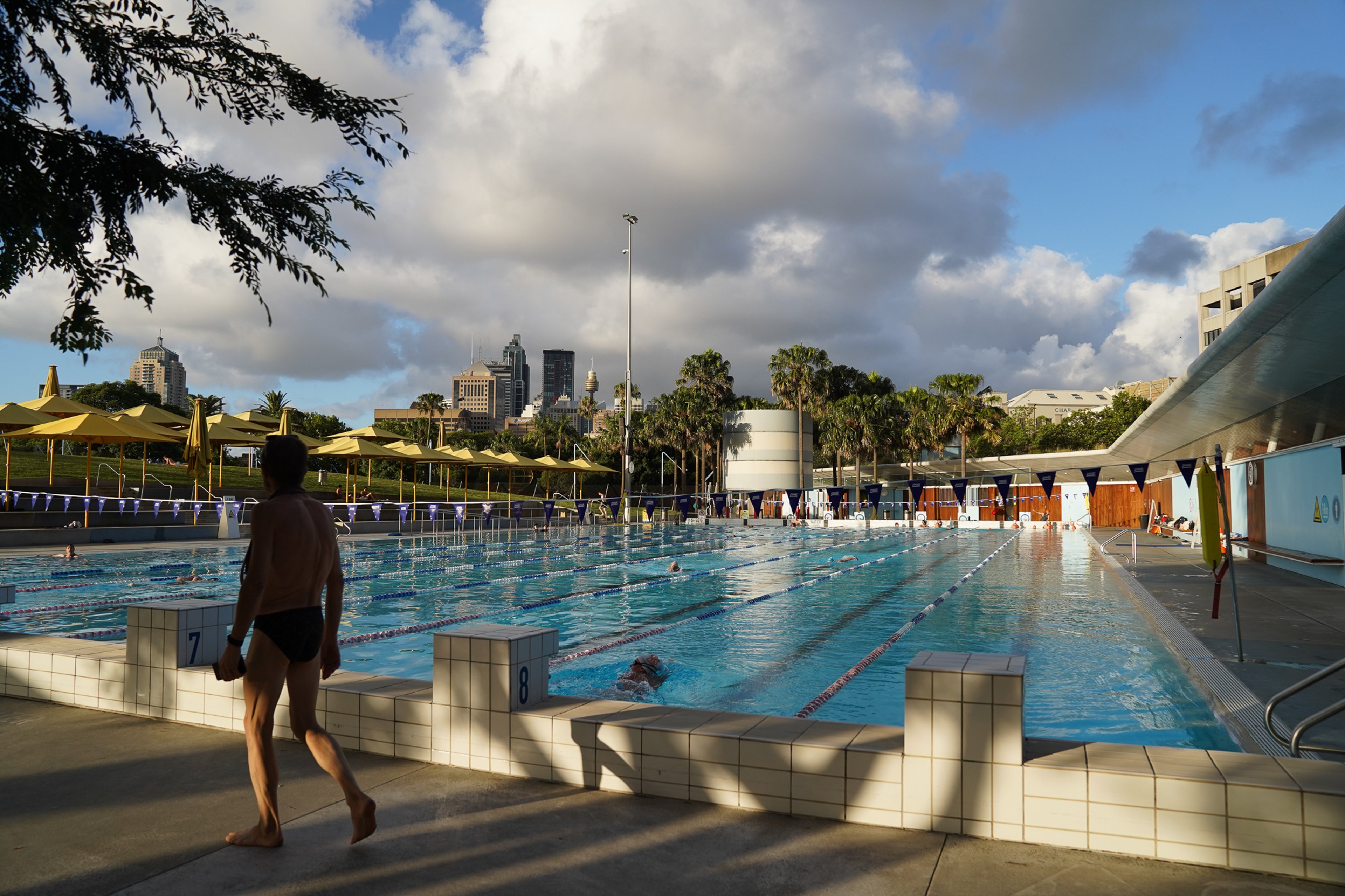 Person walking by the outdoor 50m pool Prince Alfred Park Pool