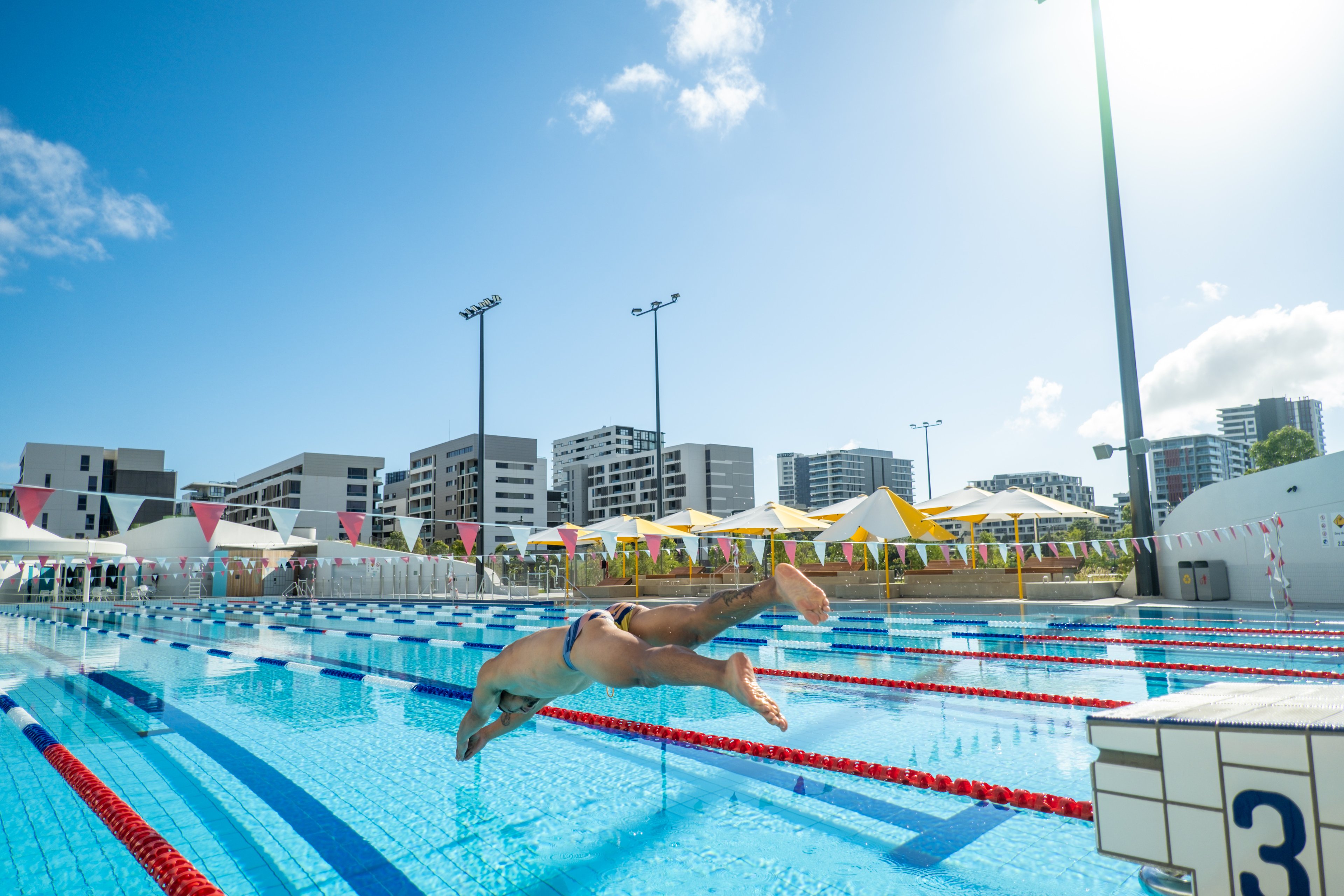 Male dives into the 50m pool at Gunyama Park Aquatic and Recreation Centre