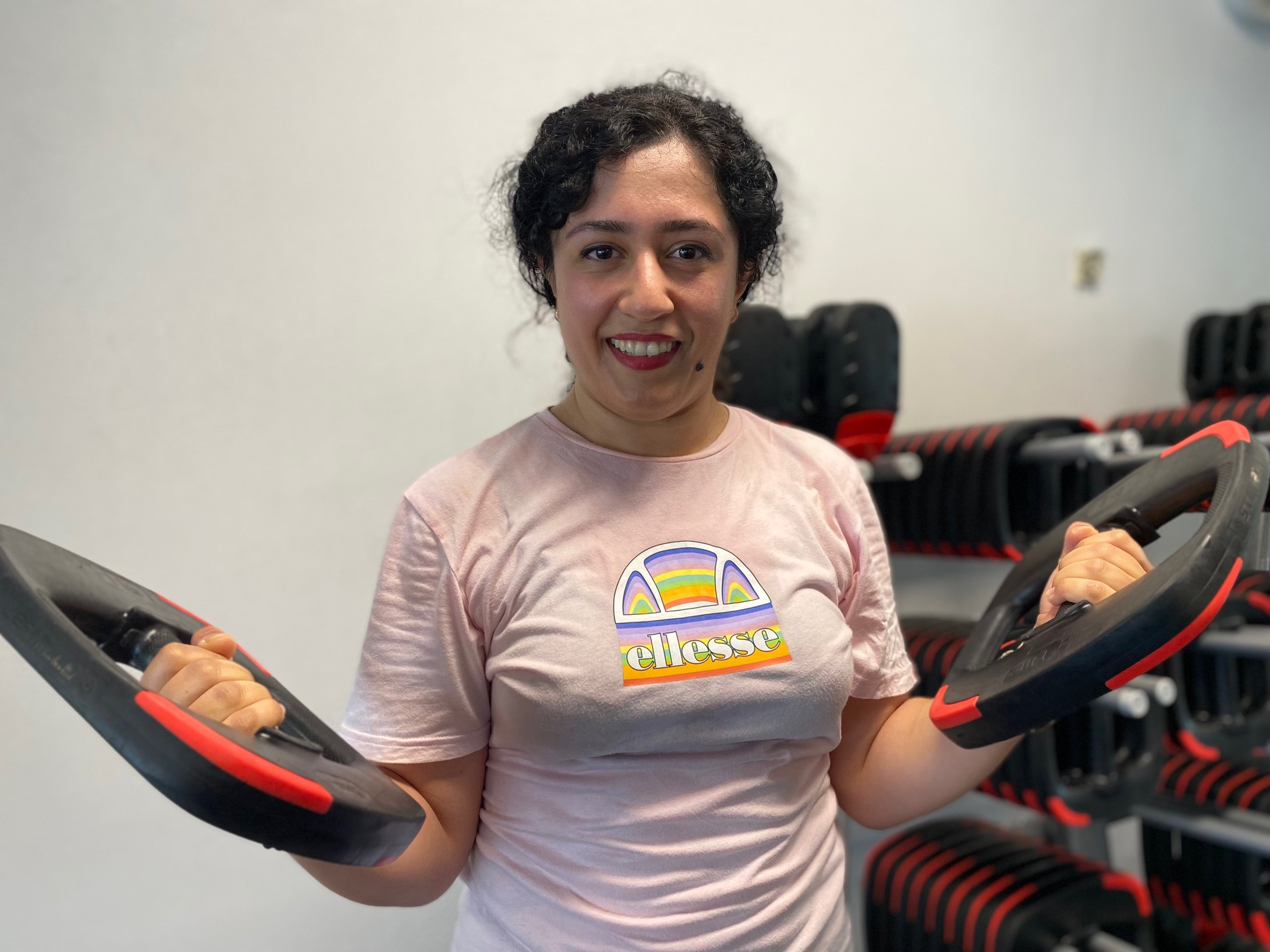 Maryam, a 360 member at Ian Thorpe Aquatic Centre, performs bicep curl using Les Mills smart weights