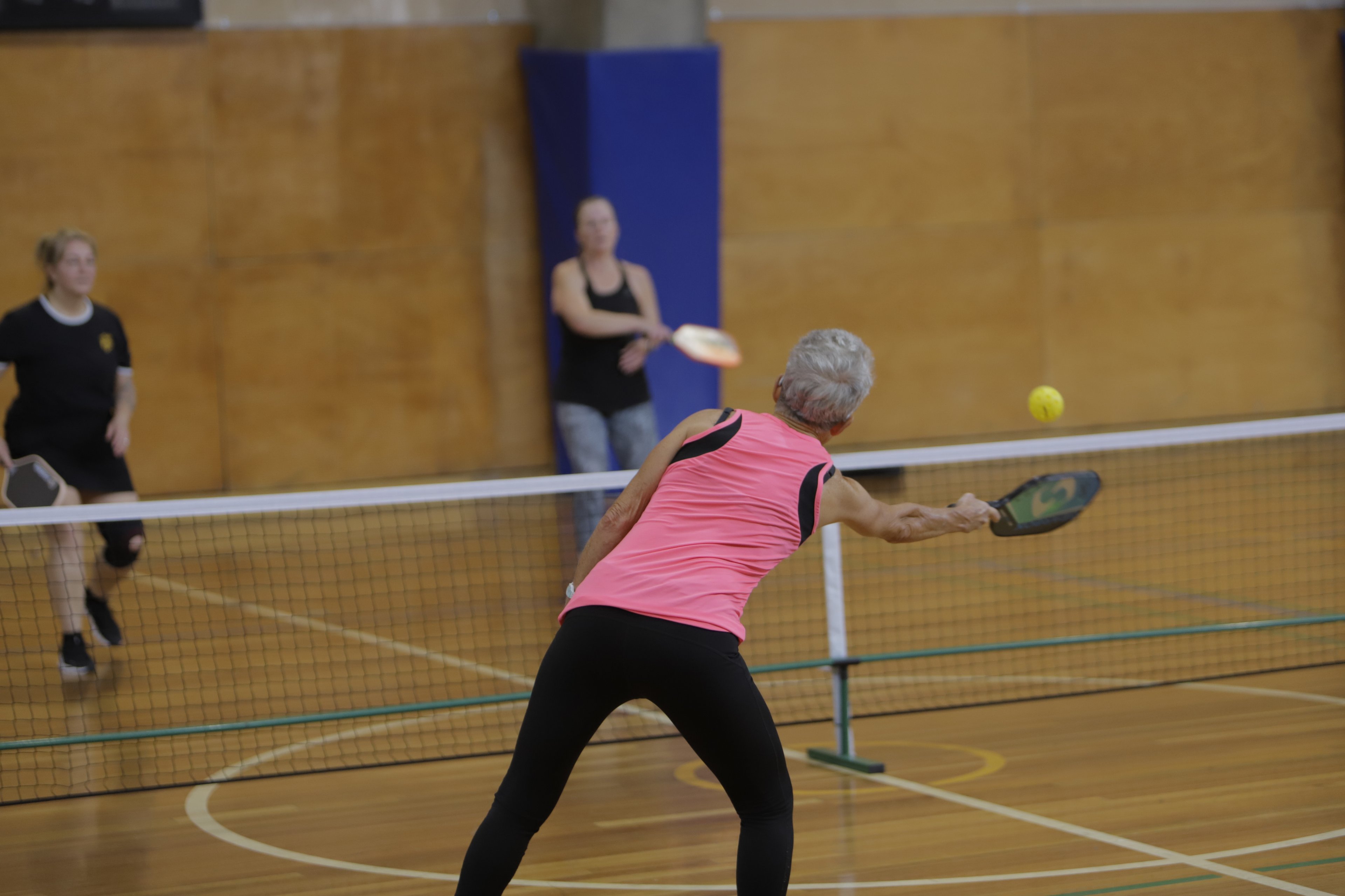 A group of people playing Pickleball on the indoor court at Cook + Phillip Park Pool