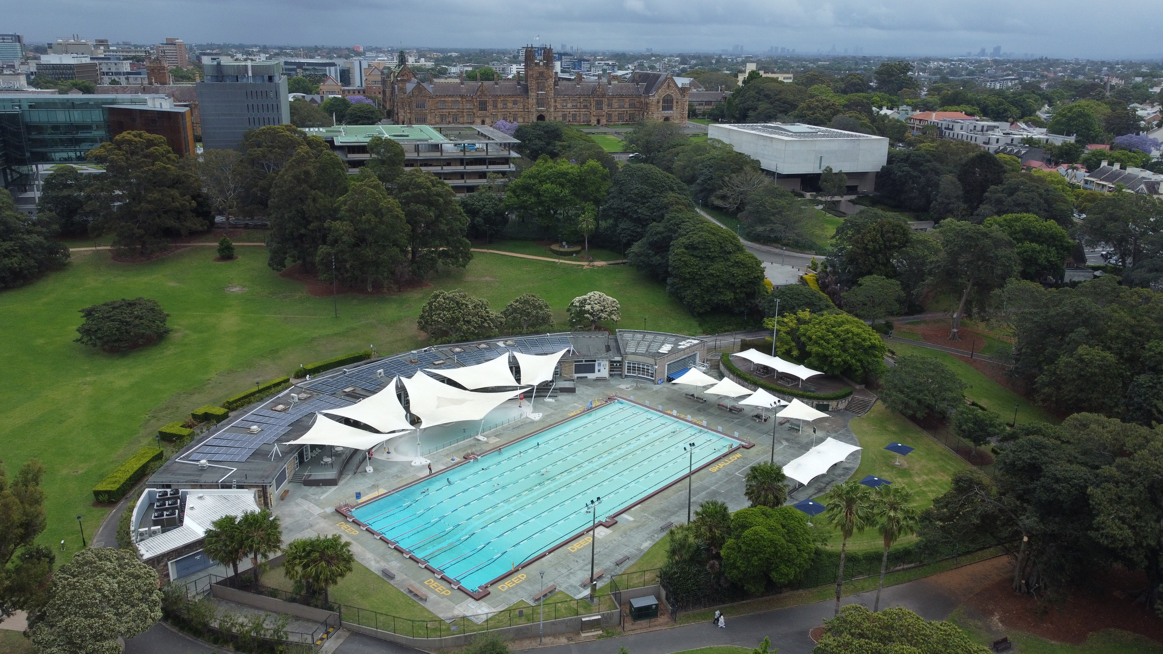 An aerial view of the outdoor pool and surrounding parklands at Victoria Park Pool