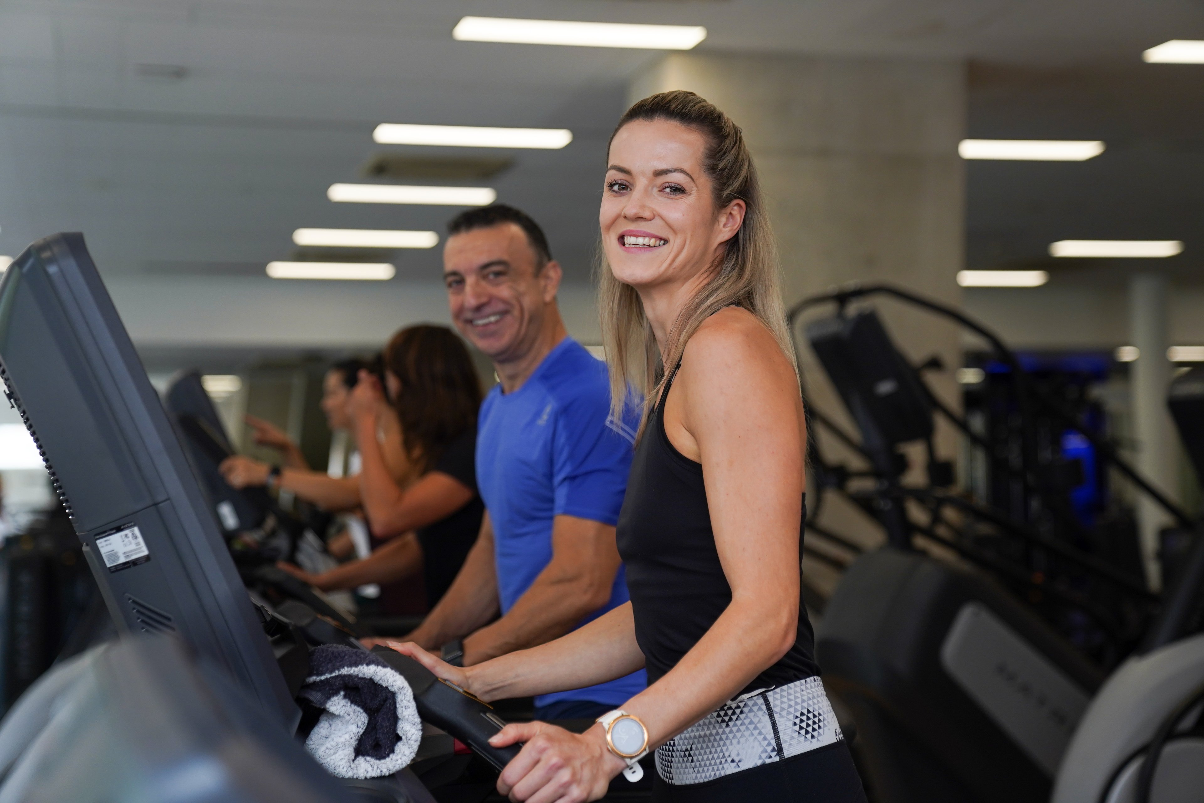 Male and female using the treadmill and smiling in the fitness centre at Ian Thorpe Aquatic Centre