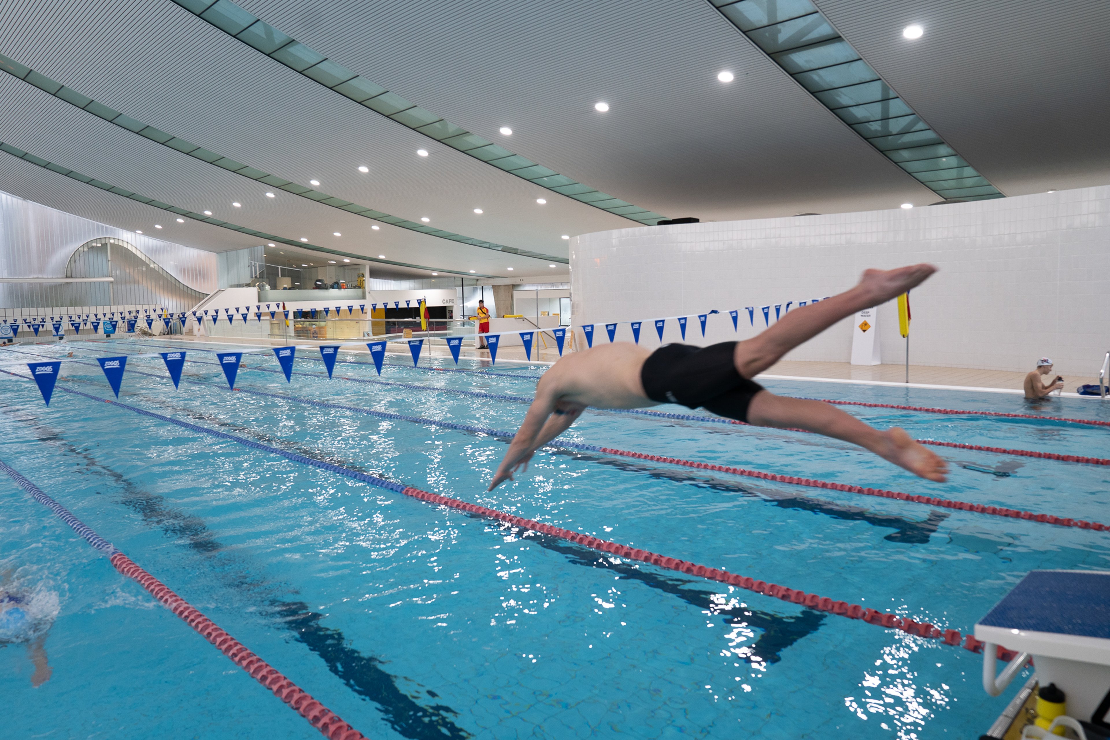 A man diving into the indoor pool at Ian Thorpe Aquatic Centre