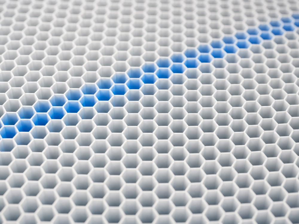 Macro view of hexagonal printed infill, the internal structure that gives a functional part its stiffness