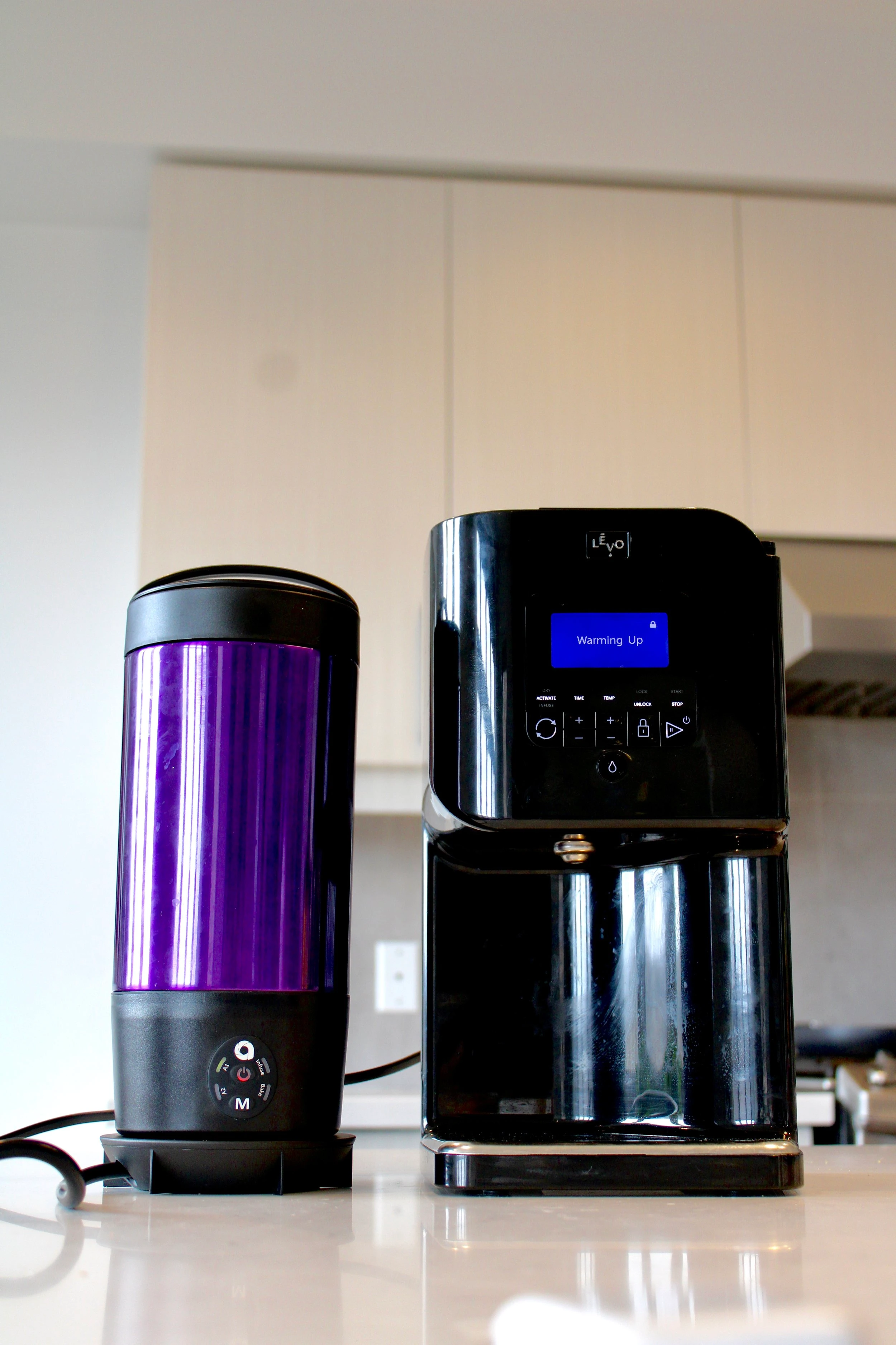 Two cannabis infusion devices (the Ardent and the LEVO) sitting next to each other.